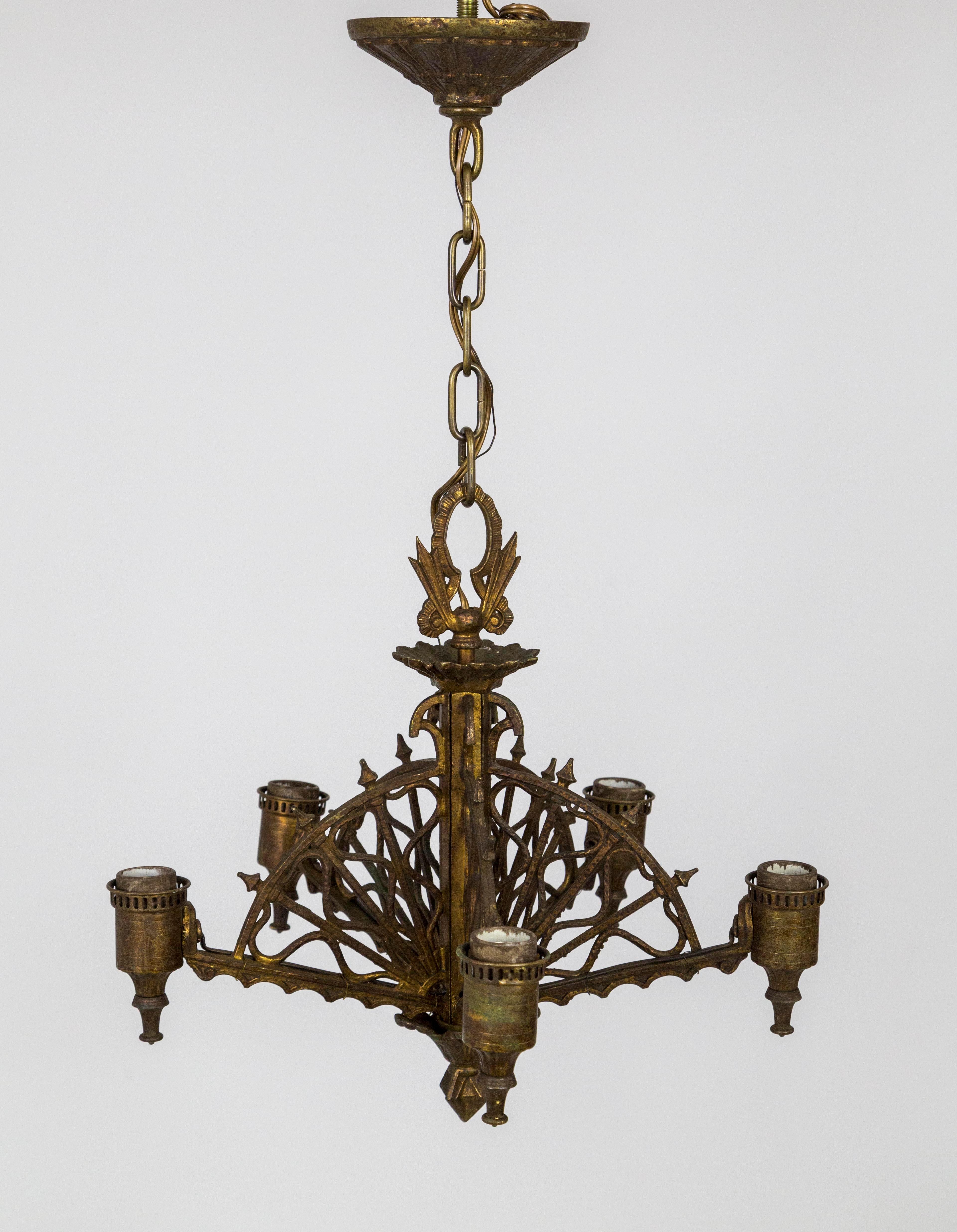 A brass chandelier with 5 arms of radial, webbed, arrows arcing to the center stem. Made by Lightolier in the early 20th century; with a complex, brass-bronze patina and decorative top hook and matching canopy. Newly wired. 24”total drop, 15
