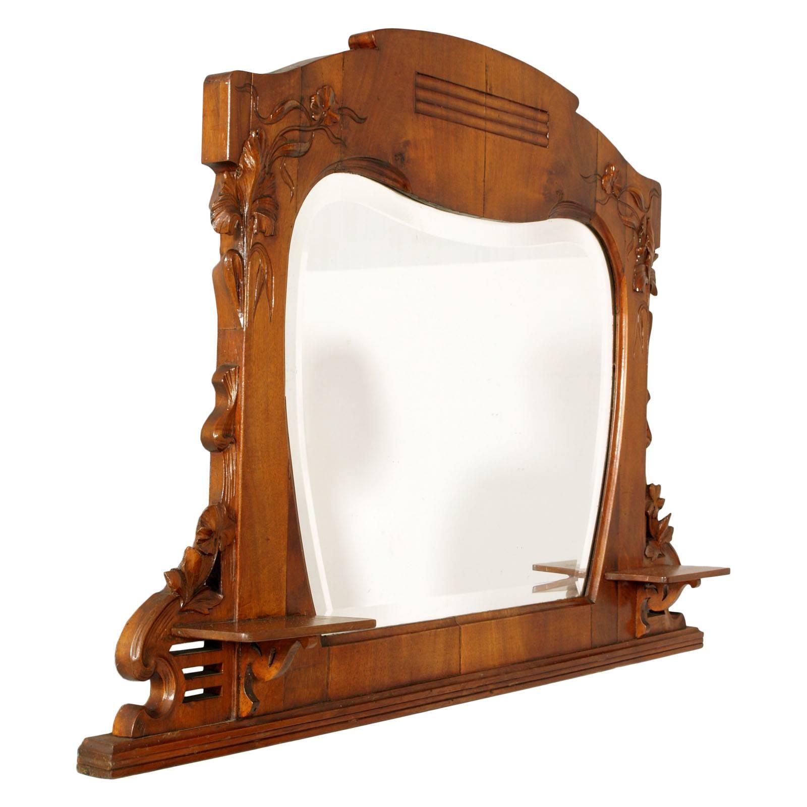 1900s mirror Art Nouveau by Testolini & Salviati, solid hand-carved walnut restored and polished to wax.
Bevelled heart mirror, hand-carved walnut with floral motifs, two side shelves.
Beautiful for a bathroom mirror

Measures cm: H 71 x W 102 x