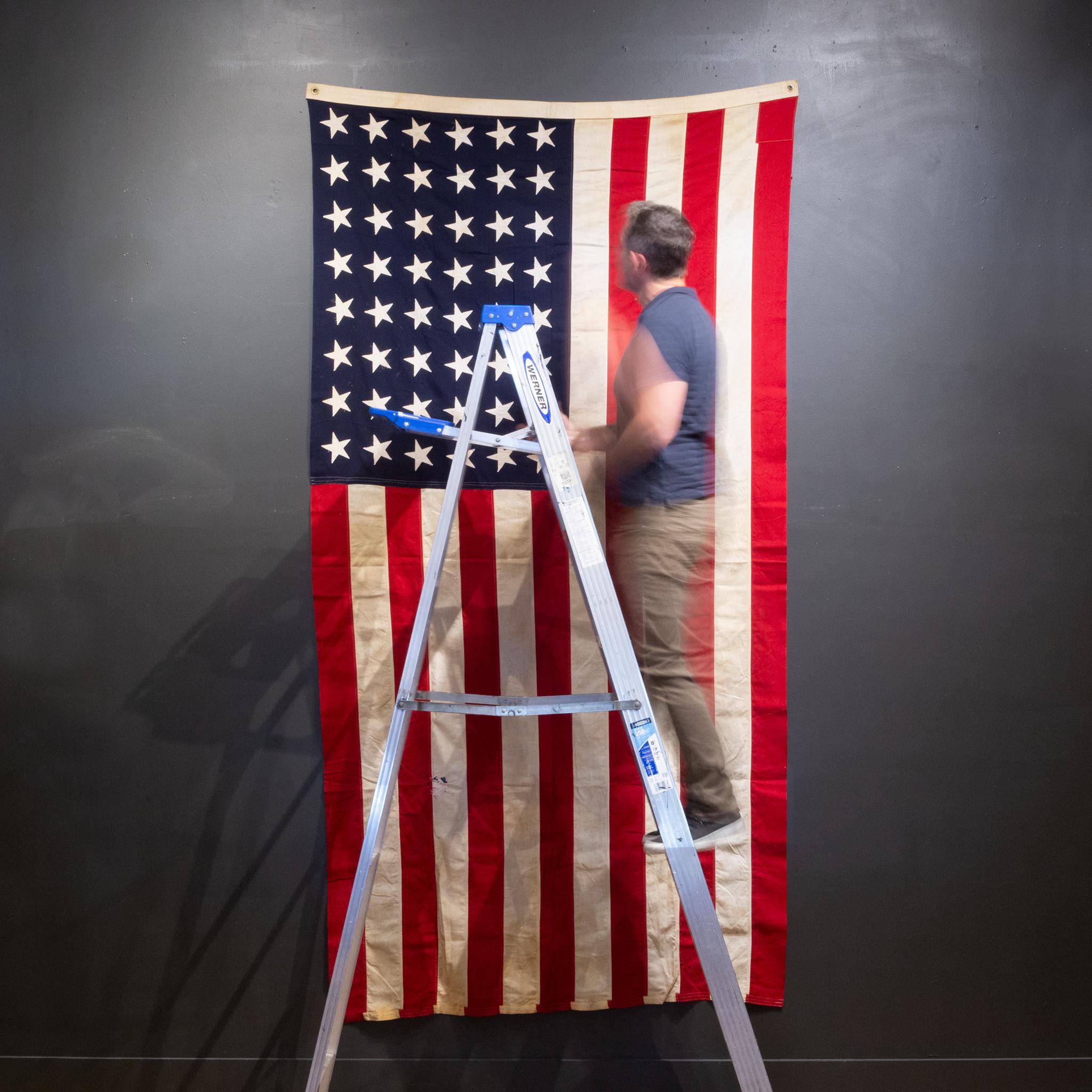 About

This is an original fabric large American flag with 48 hand sewn stars and metal grommets to hang it. The flag has retained its original color with some structural damage and slight fading.

Creator unknown.
Date of manufacture