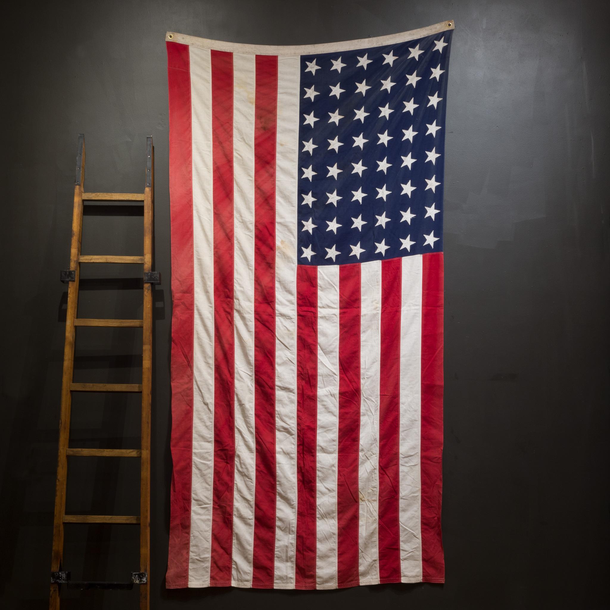 About

This is an original monumental American flag made with 48 hand sewn stars and stripes. It is in good condition and has brass grommets to hang.

Creator unknown.
Date of manufacture c.1940-1950.
Materials and techniques cotton,