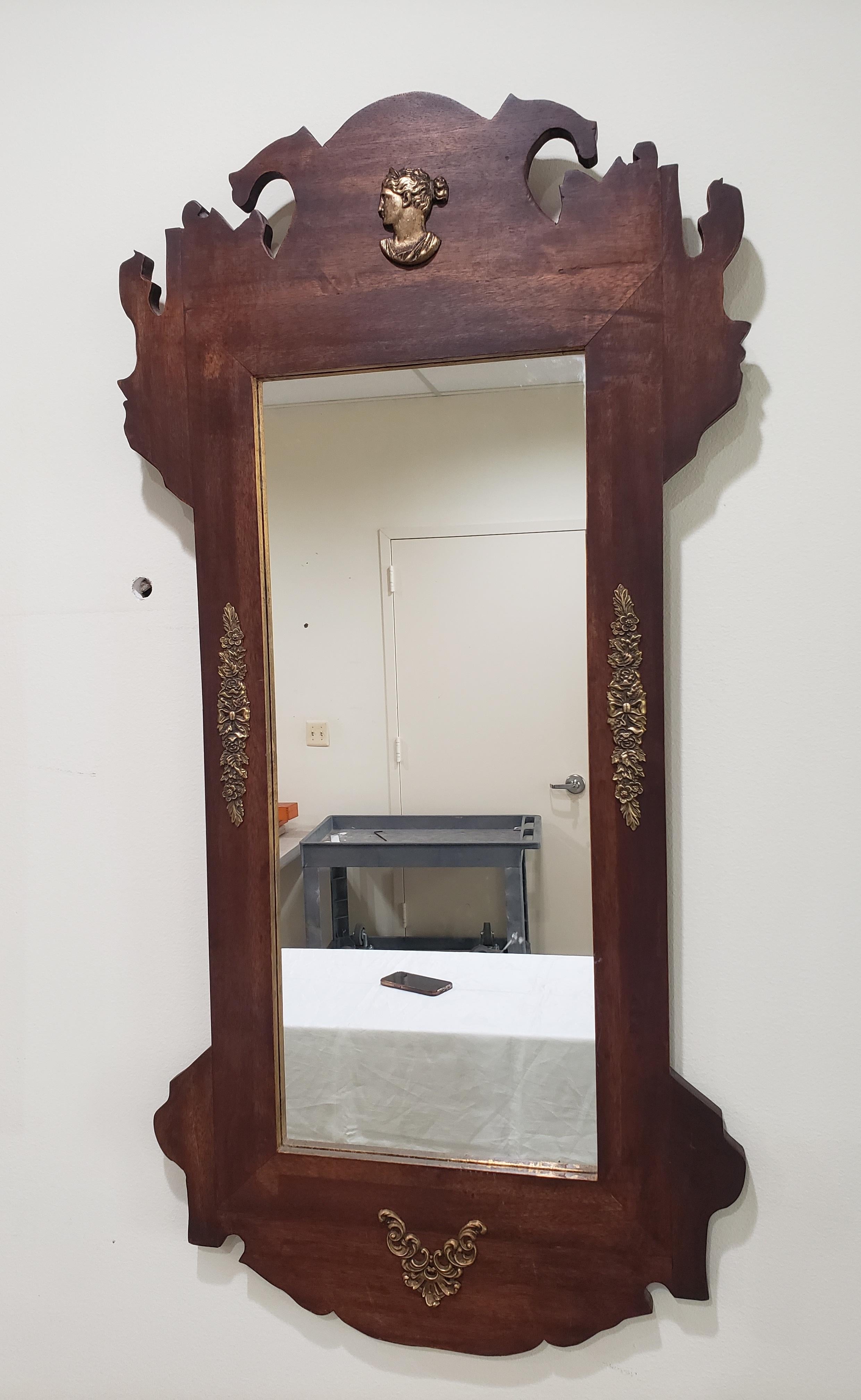 An Early 20th C Neoclassical Bronze Mounted and Partial Gilt Mahogany Scroll-Ear Mirror in good condition. Solid Mahogany frame. Measures 20.5