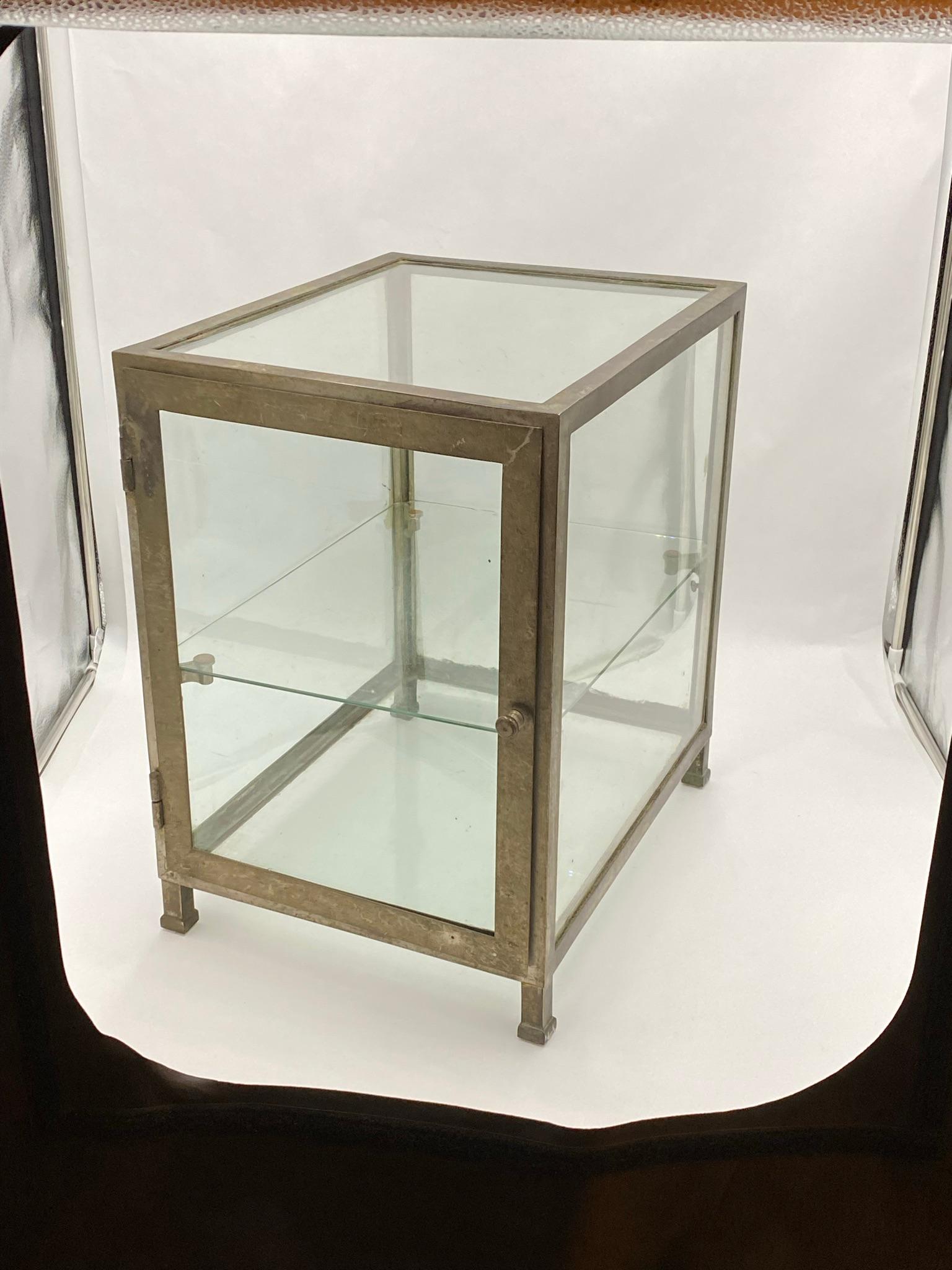 Early 20th century counter top display case. Frame is nickel plated brass and comes with one glass shelf. Front door sticks slightly. From France. This can be seen at our 333 West 52nd St location in the Theater District West of Manhattan.