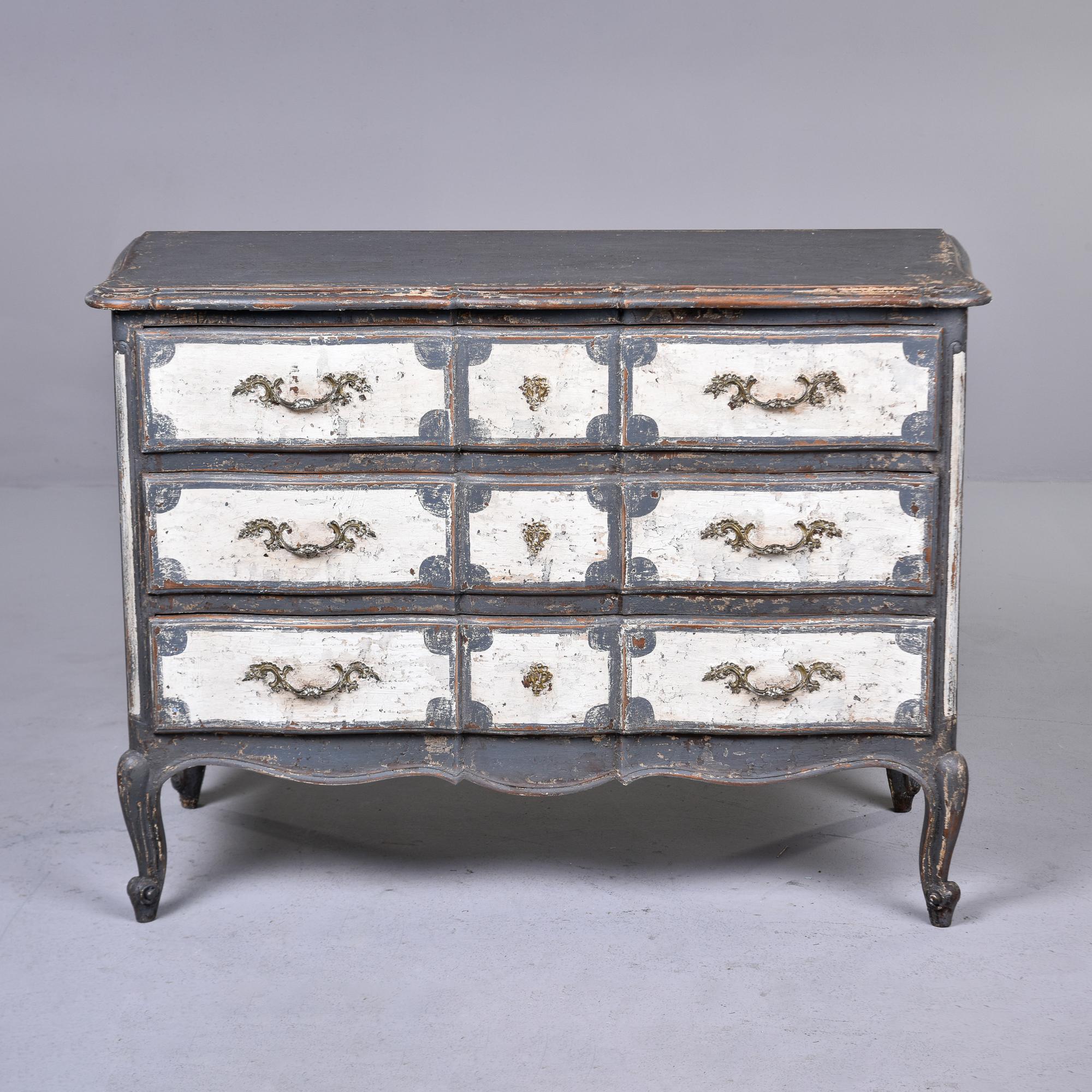 Found in France, this three drawer chest dates from approximately 1900. Original hardware, carved details, dovetail construction and classic French-style curved legs. We found this piece as shown, but do not believe the decorative gray and antique