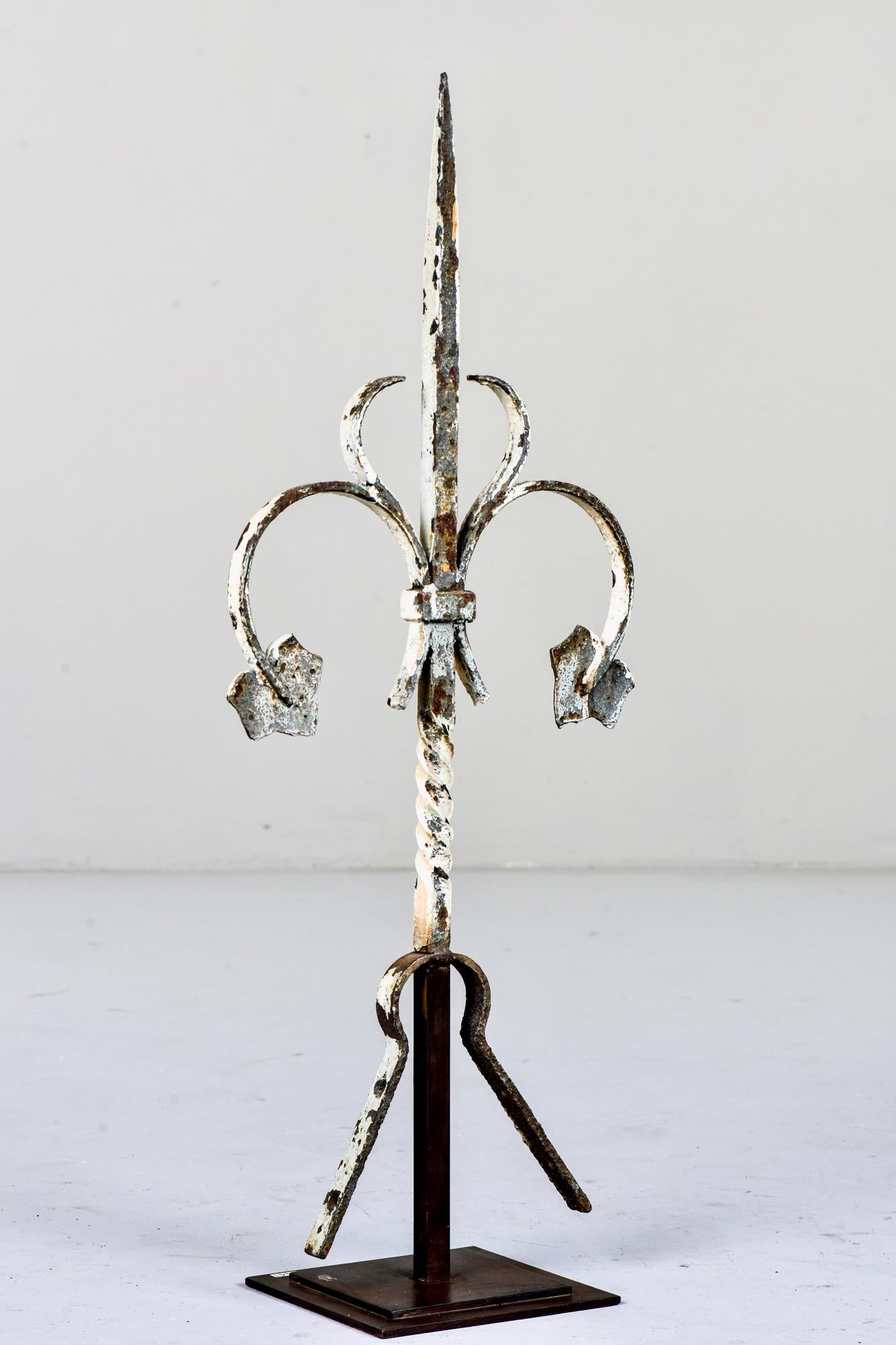 Found in England, this circa 1900 iron finial has ivy leaves and a white painted finish. Mounted on a custom iron display stand. Unknown maker.