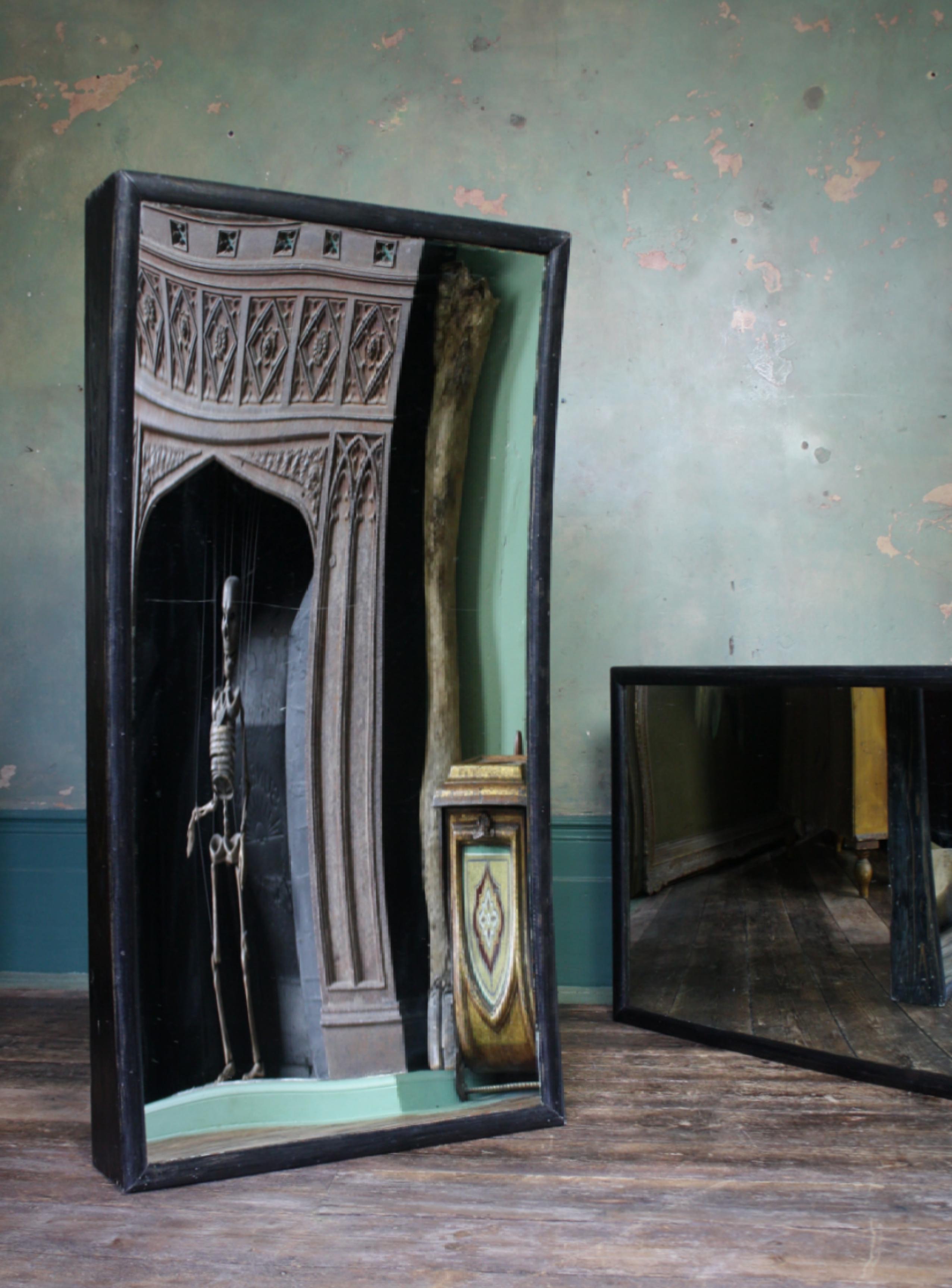 A rare pair of obverse fairground mirrors, housed in their original pine frames and ebonised finish.

The original concave and convex optical glass is of sound condition with minor surface wear considering the nature of a travelling circus, there