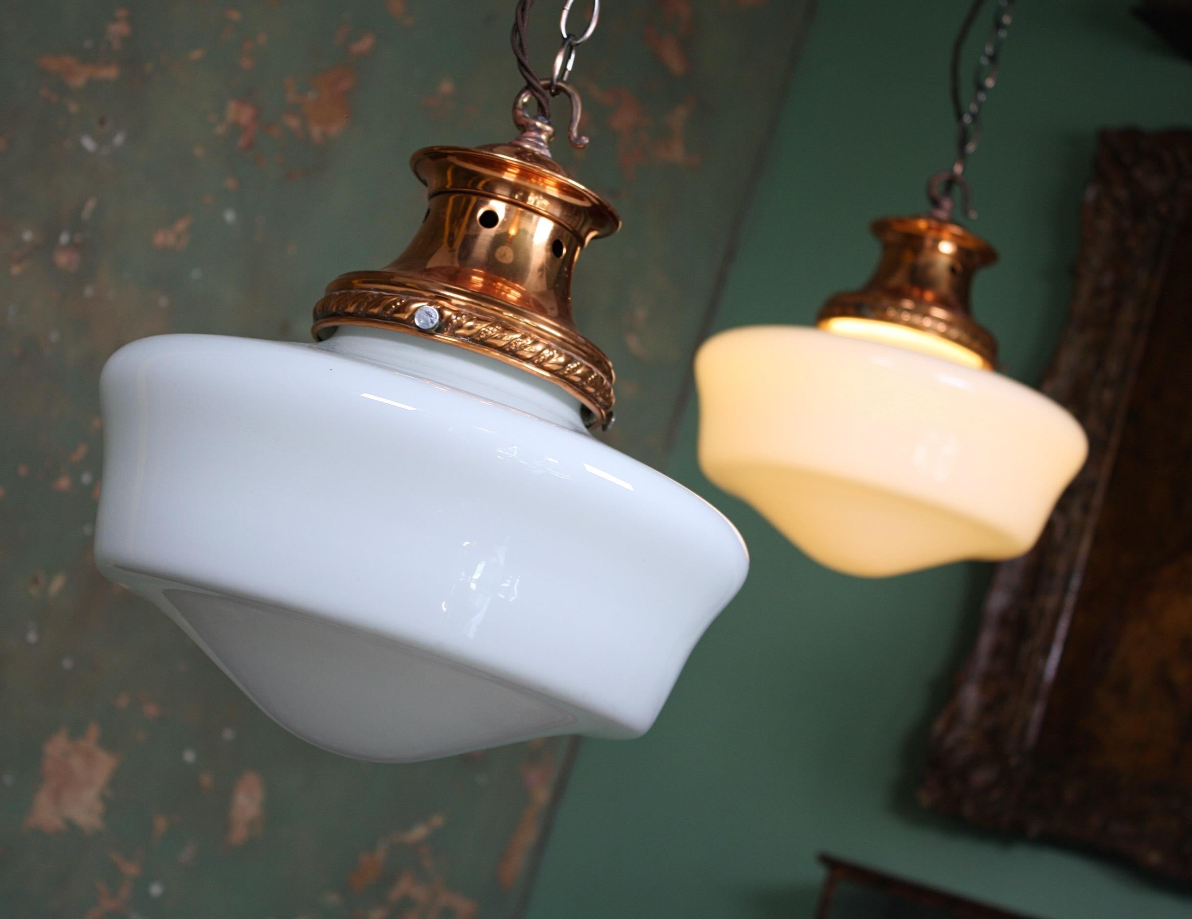 A good clean pair of opaline glass pendants, with their original copper galleries with pressed decoration. 

The galleries have been cleaned, polished and lacquered, glass sections in perfect condition.

The lights comes with new aged copper