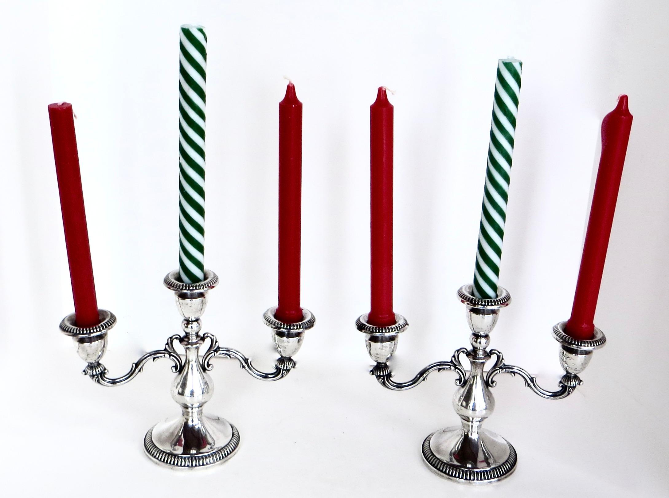 Pair of early 20th century Art Nouveau sterling silver three armed candlabras in excellent and completely all original condition with all parts and elements intact, including drip trays. Branches extend laterally to allow for three mid sized candles