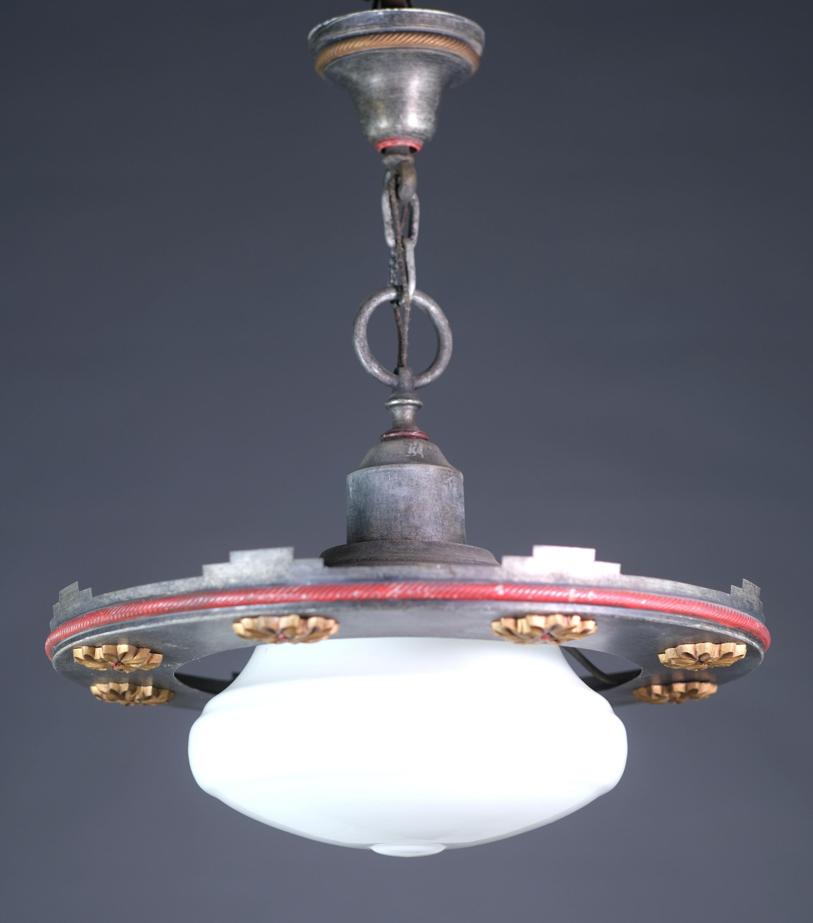 Unusual early 20th century short pendant light. Outside black ring features a series of gold painted florets. Red details. This can be seen at our 400 Gilligan St location in Scranton, PA.