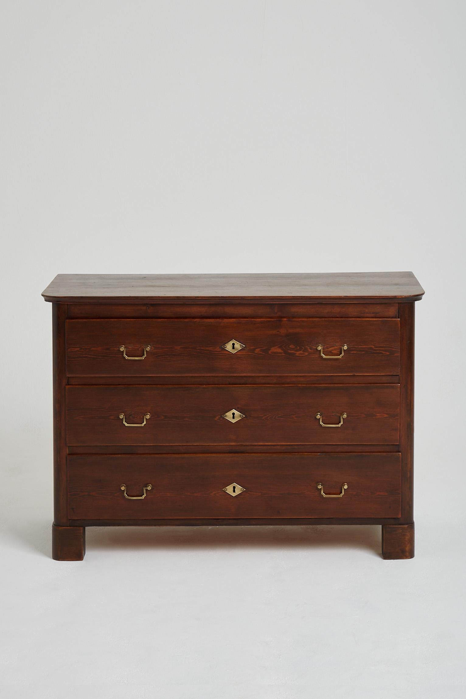 A stained pine and brass mounts chest of drawers.
Sweden, Circa 1930-1940.