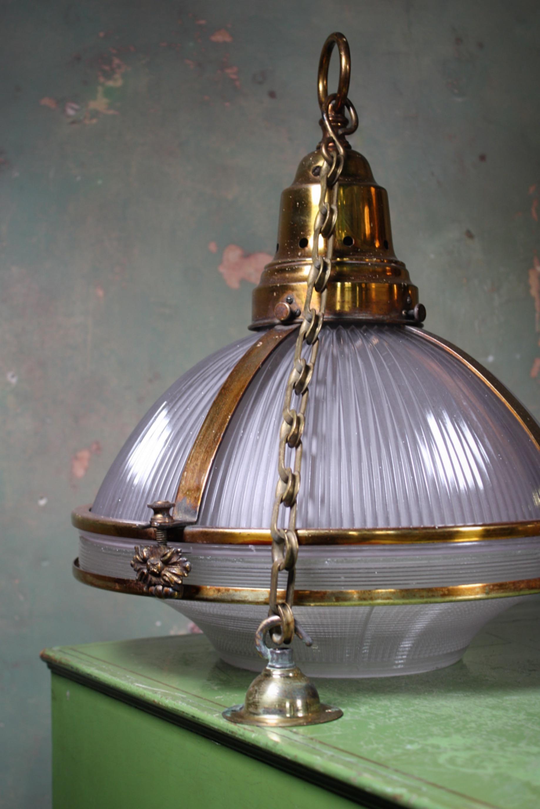 A very rare pair of violet tinted three part prismatic glass Holophane lanterns, housed within their original elaborate gilt copper cages, early 20th century.

The gilt copper (over brass) has a wonderful patina, with the finish over time almost