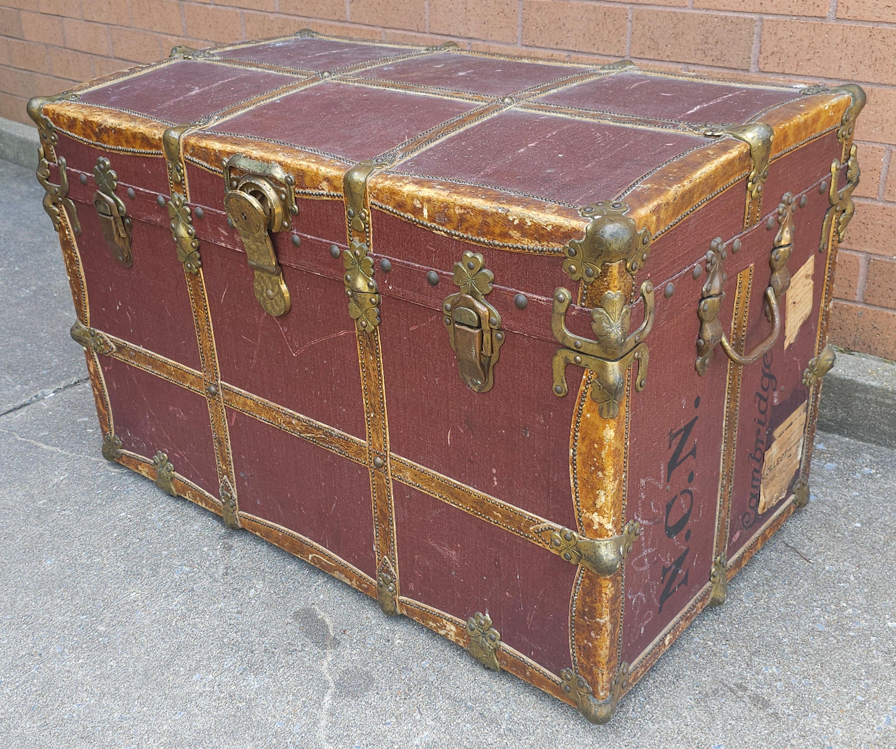 A well kepth Late 19th Century to  Early 20th Century Rawleys Brass and Leather Bound On Canvas rolling Wardrobe Trunk in great antique condition. Solid brass fitting throughout, hardened canvas and all around leather bound. Measures 34