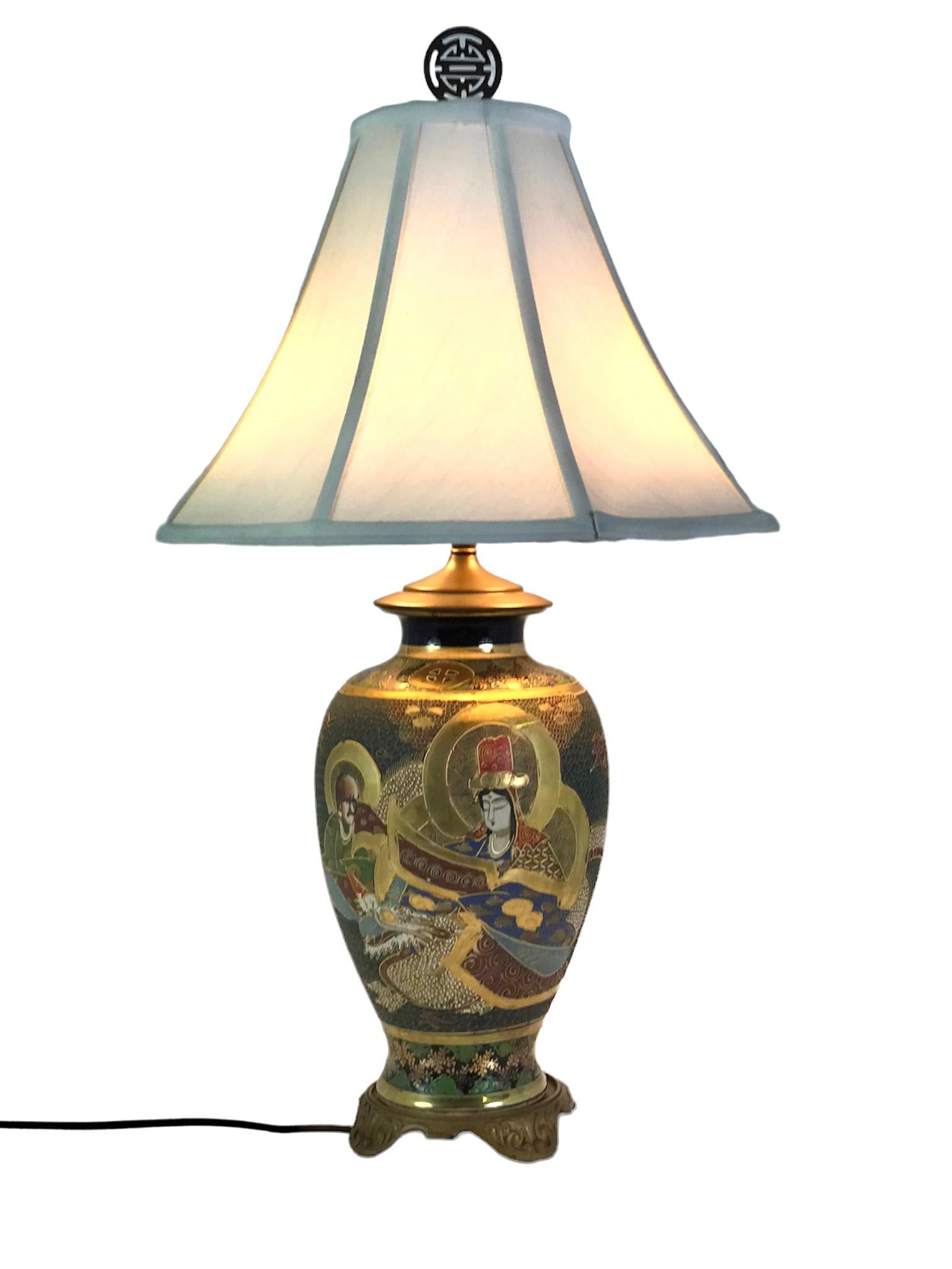 Antique Japanese Satsuma pottery table lamp decorated with hand-painted figures of a group of Immortals with He Xiangu holding scroll. This type of decoration of the Immortals conveys good luck, peace, fortune and happiness. Done in gilt and