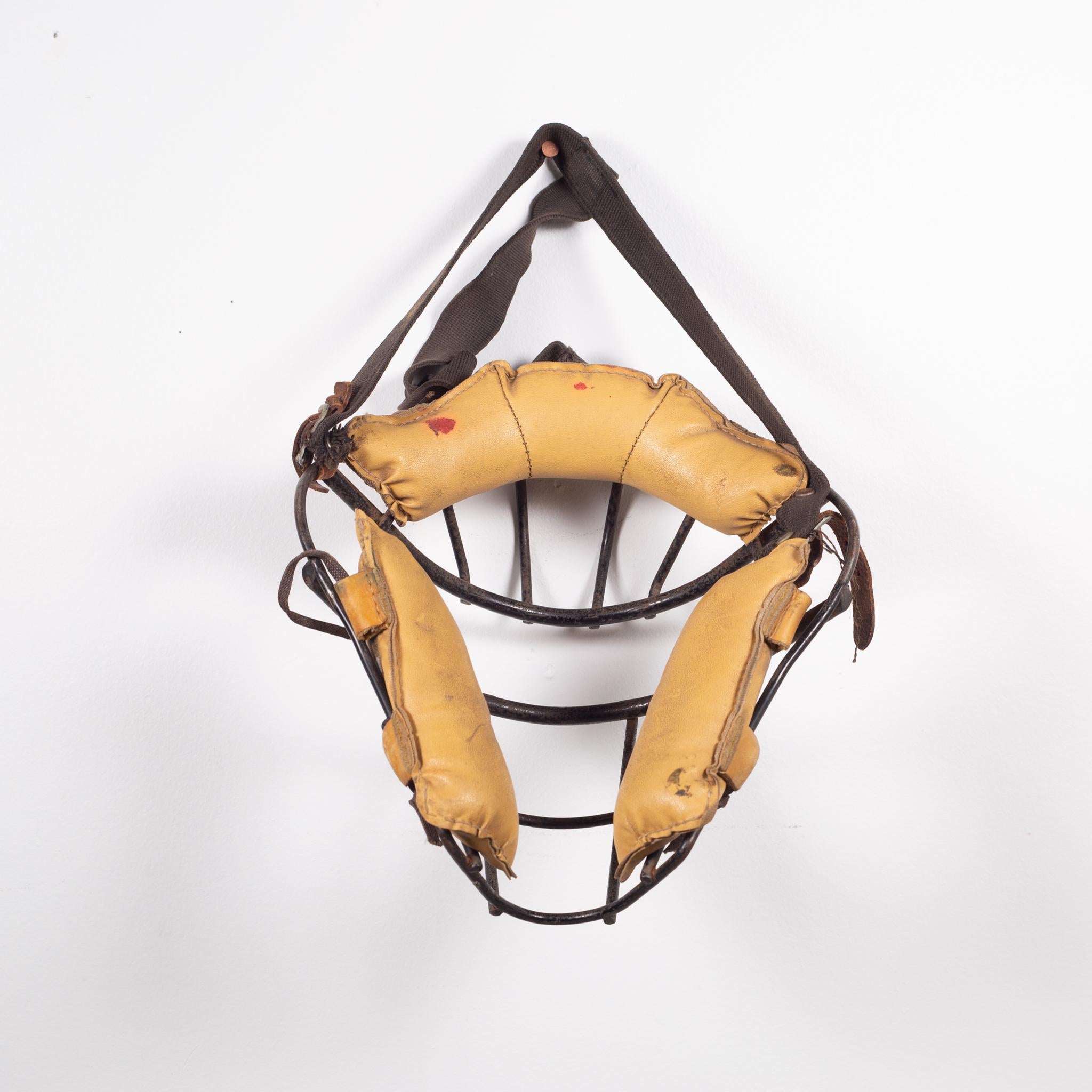 About

This is an original vintage catcher's mask. The main body is heavy steel with thick leather padding and fabric head strap. The padding is held onto the body of the mask by leather straps with snaps. The piece has retained most of it's