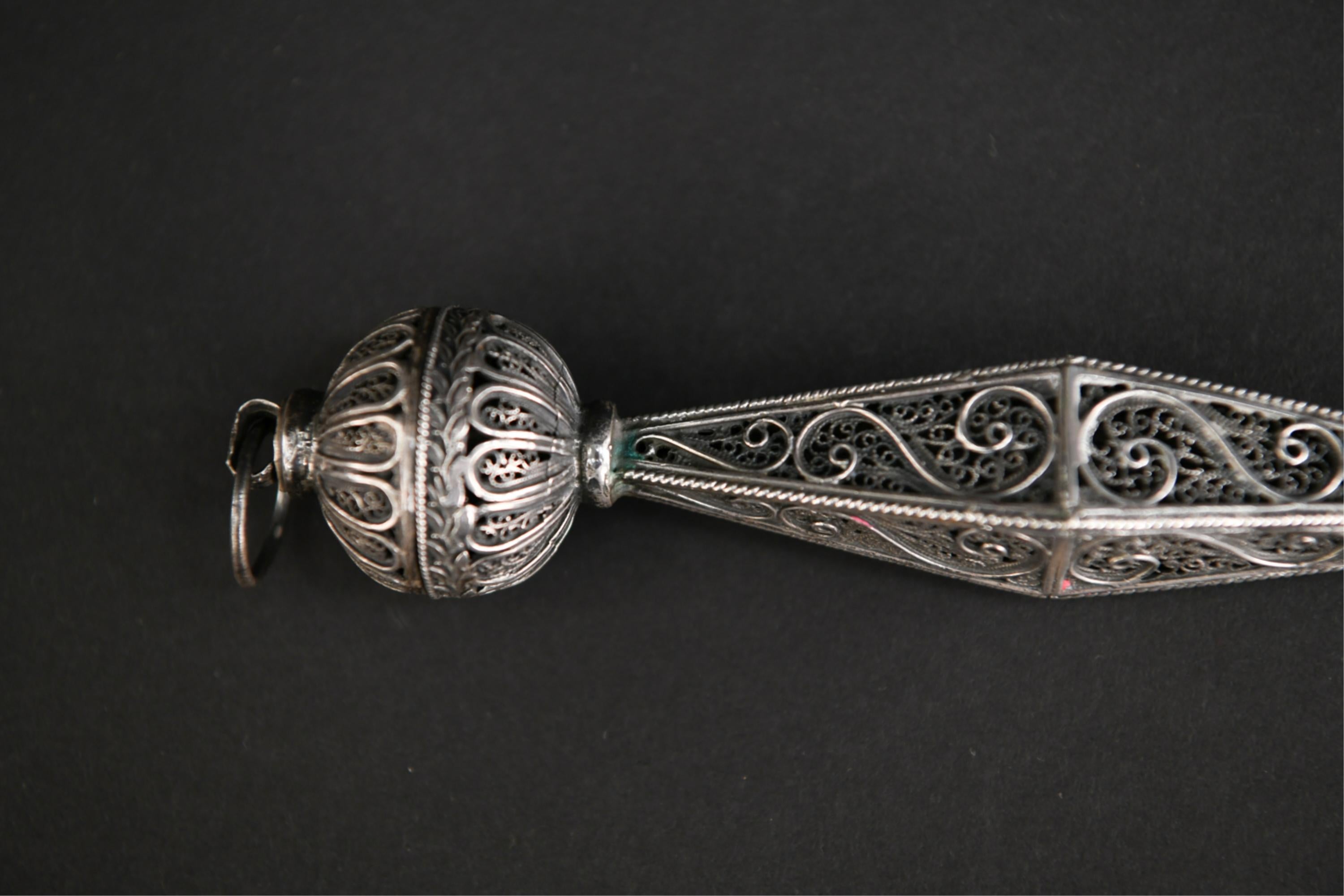 The intricate openwork floral and scroll motifs of this Torah pointer - known as a Yad - indicate the work of a master silver artist. Yad is stamped 