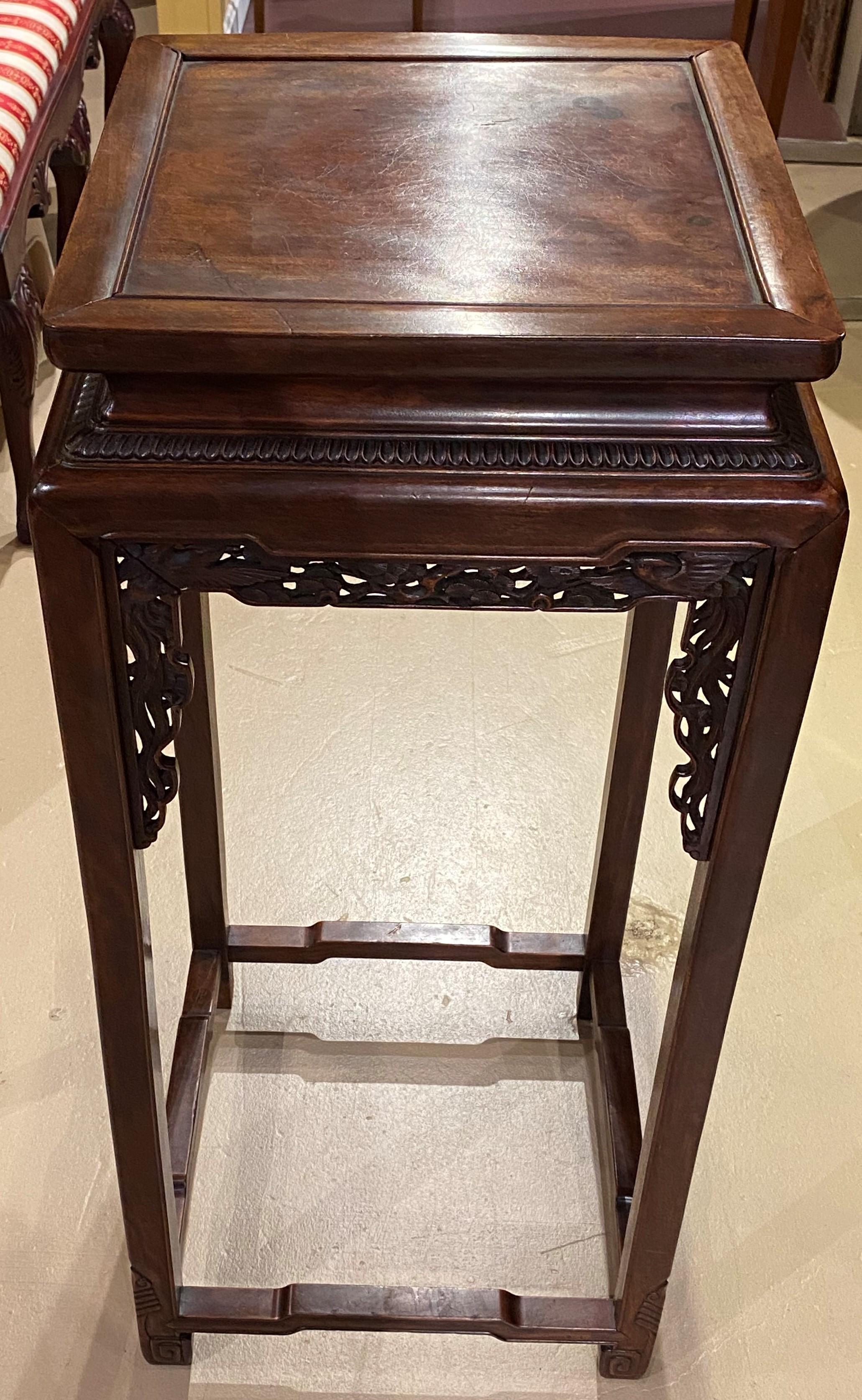 A fine tall Chinese hardwood square side table with subtle pierce carved bird and foliate decoration, dating to the early 20th century in very good overall condition, with some slight shrinkage, minor top stains and imperfections, as well as light
