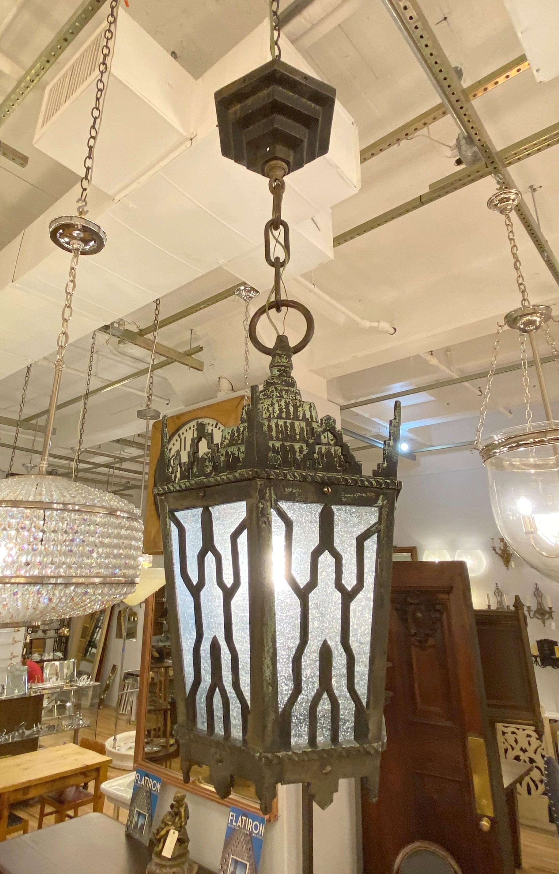 Early 20th century bronze Art Deco exterior ceiling lantern. Great for a foyer. Features seeded glass and a four tiered hexagon shaped matching canopy. Cleaned and restored. This takes one standard medium base light bulb. Please note, this item is