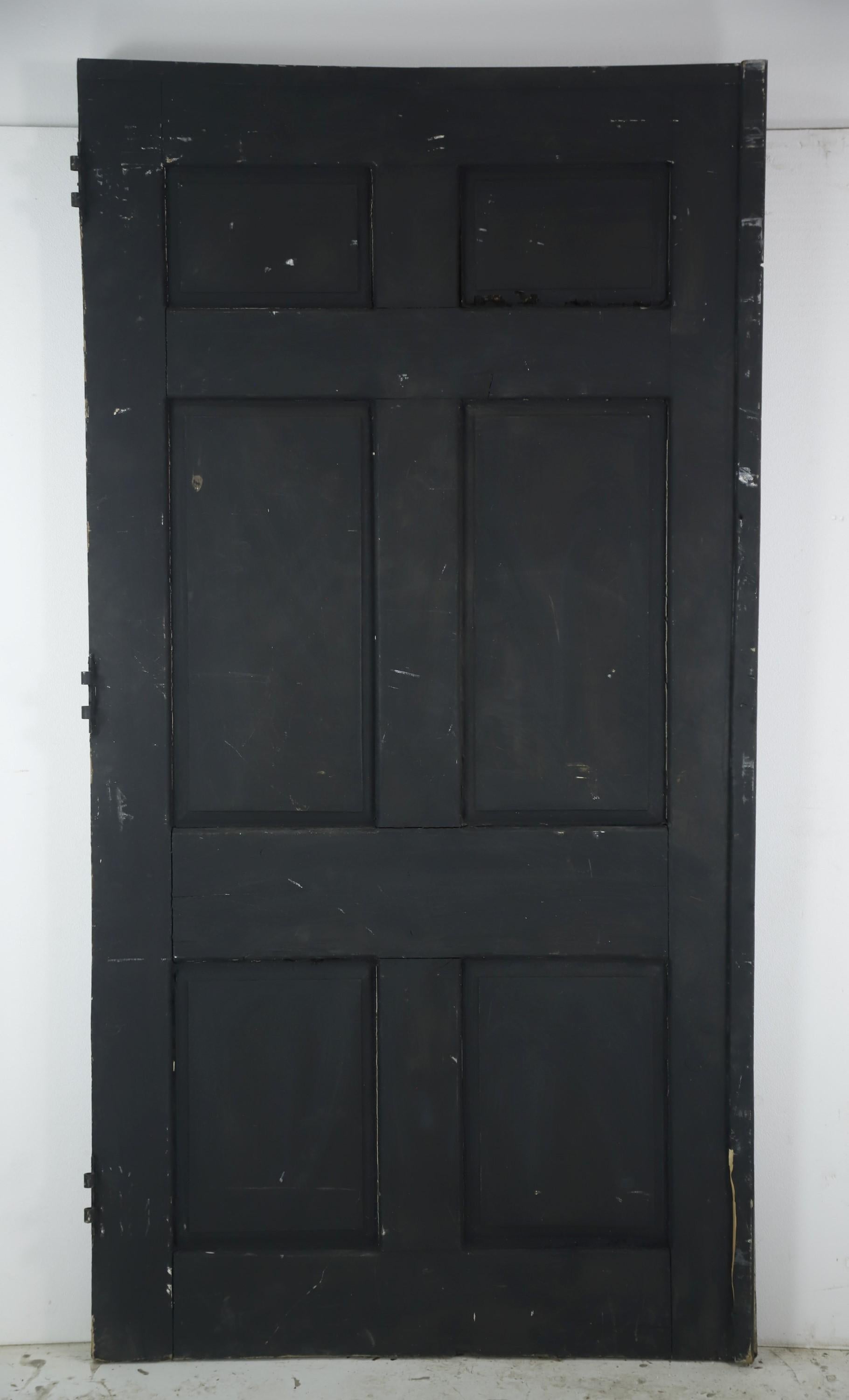 Early 20th Century extra wide black wood door featuring six panels and some of the original hardware, which has been painted over. Overall in good condition, with typical surface wear. Please note, this item is located in our Scranton, PA