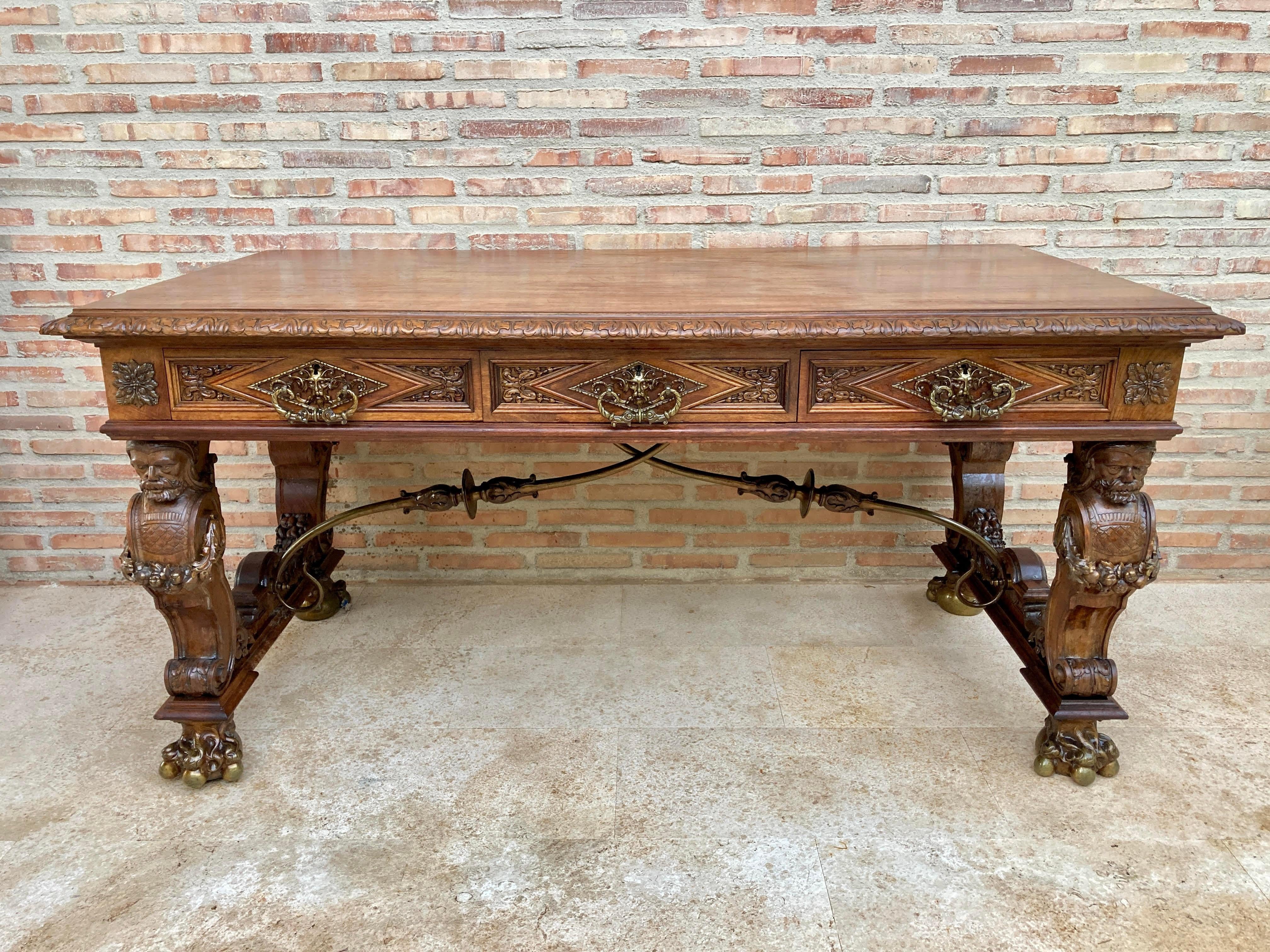 The 19th century Spanish Renaissance walnut desk is a splendid example of the breed, with classical architecture enhanced by hand-carved reliefs in an abstract expression of the Renaissance style. Four carved columns representing the lords form the