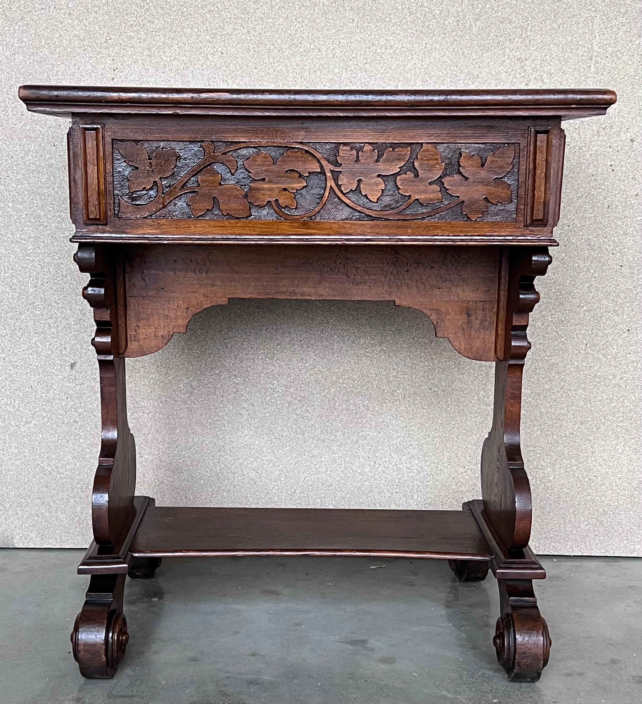 Early 20th carved walnut side table or cart with large drawers and wheels.