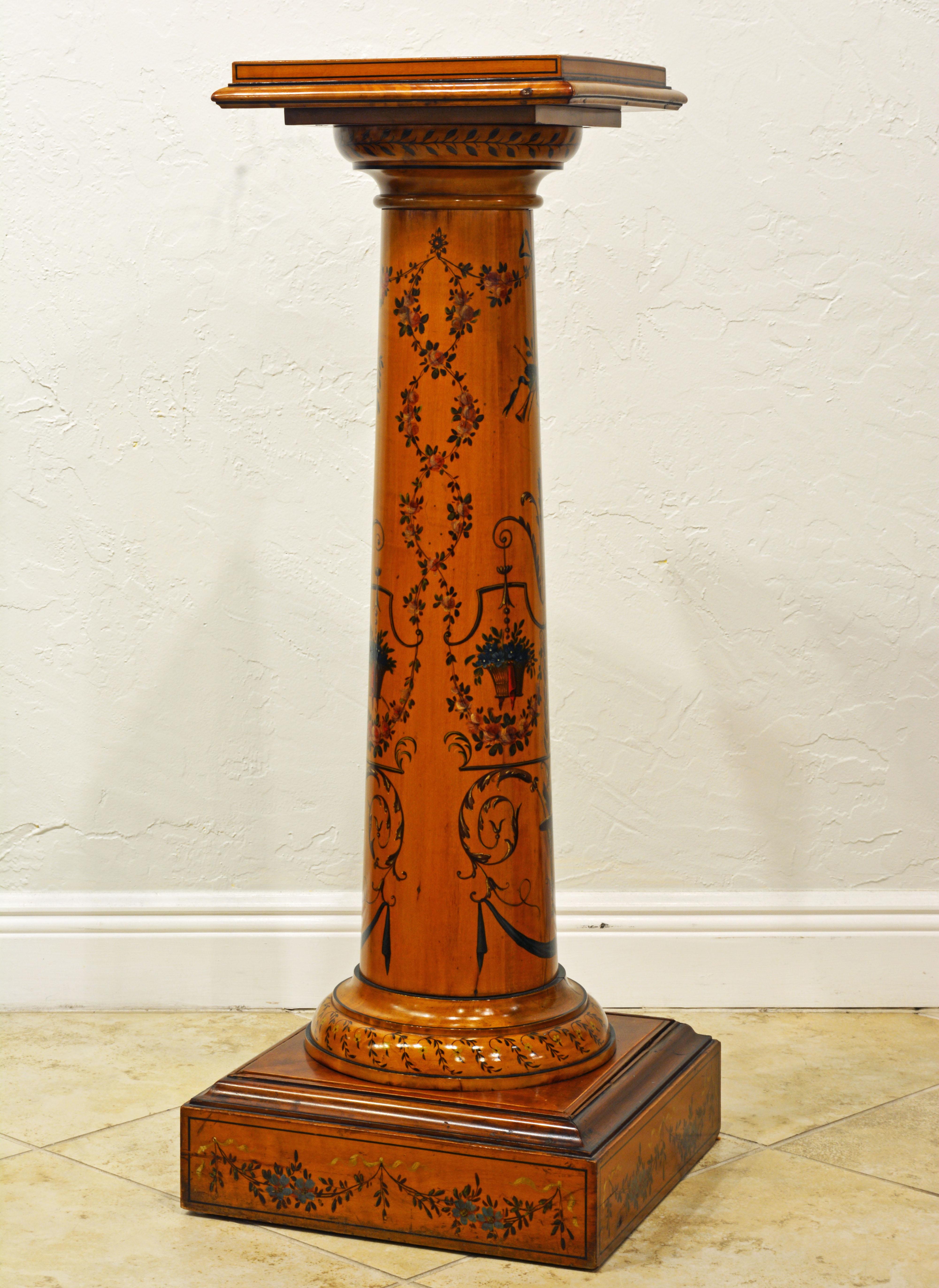 This graceful Edwardian satinwood column pedestal is fashioned as a classical column in the Greco-Roman style. It is in two parts as shown on the photos. All surfaces are delicately painted in the Adam style featuring urns, garlands and flowers.