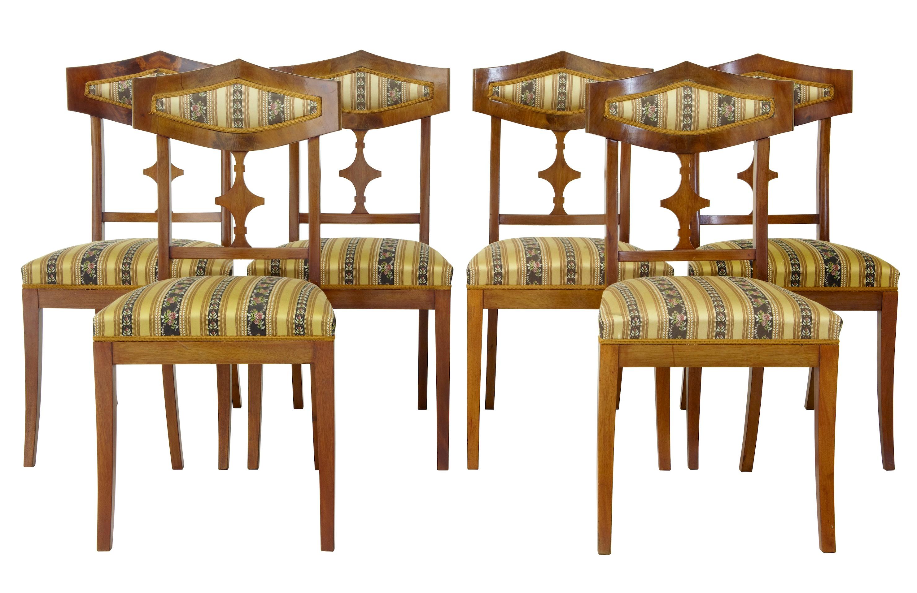 Large suite of furniture consisting of one sofa, four armchairs, six single chairs and two stools, circa 1910.
All upholstered in matching fabrics.
Flame mahogany veneers.
Obvious signs of use with surface marks to legs.

Stool