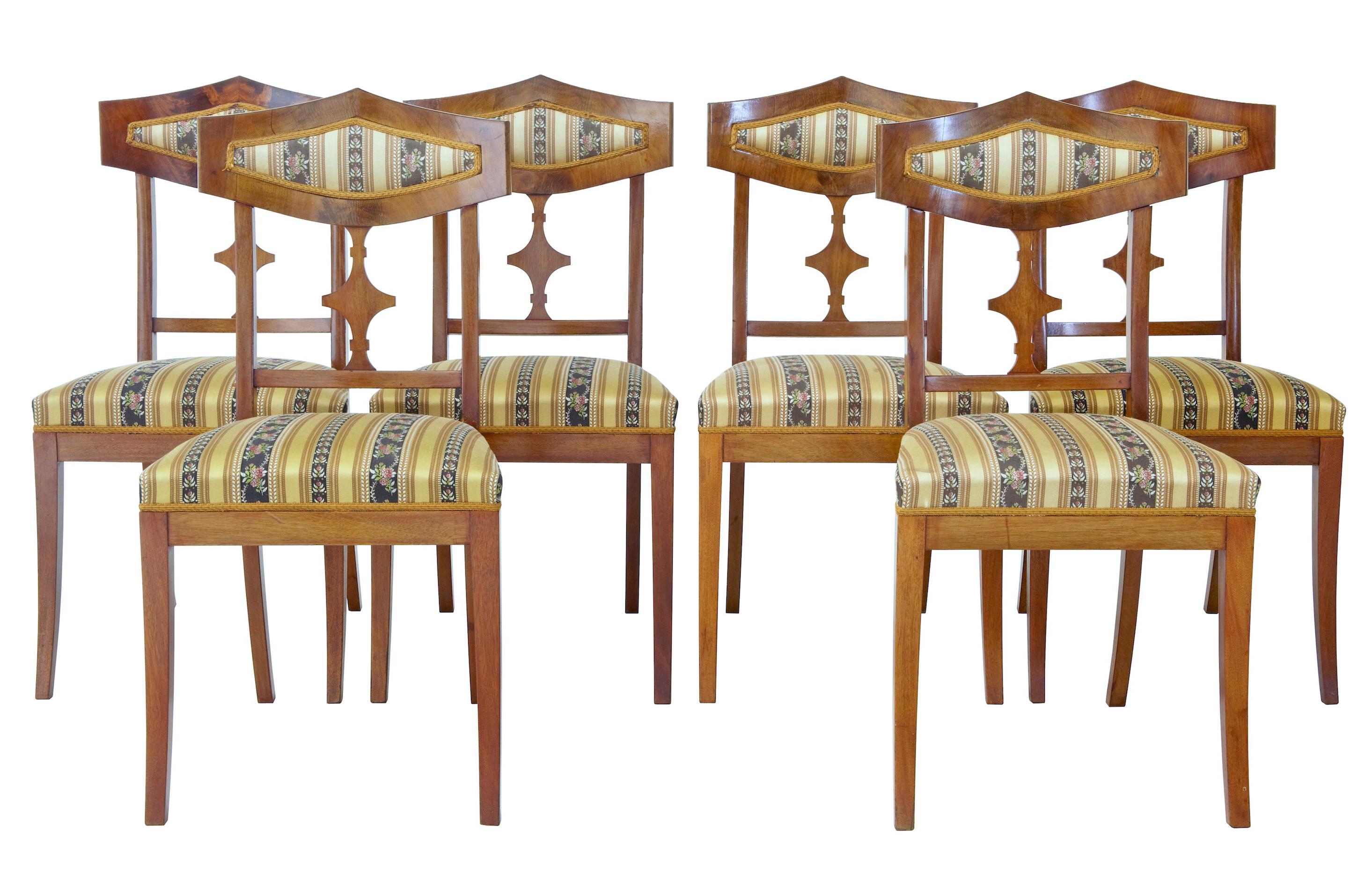 Large suite of furniture consisting of 1 sofa, 4 armchairs, 6 single chairs and 2 stools circa 1910. All upholstered in matching fabrics. Flame mahogany veneers.

Obvious signs of use with surface marks to legs.

Measures: Stool height: