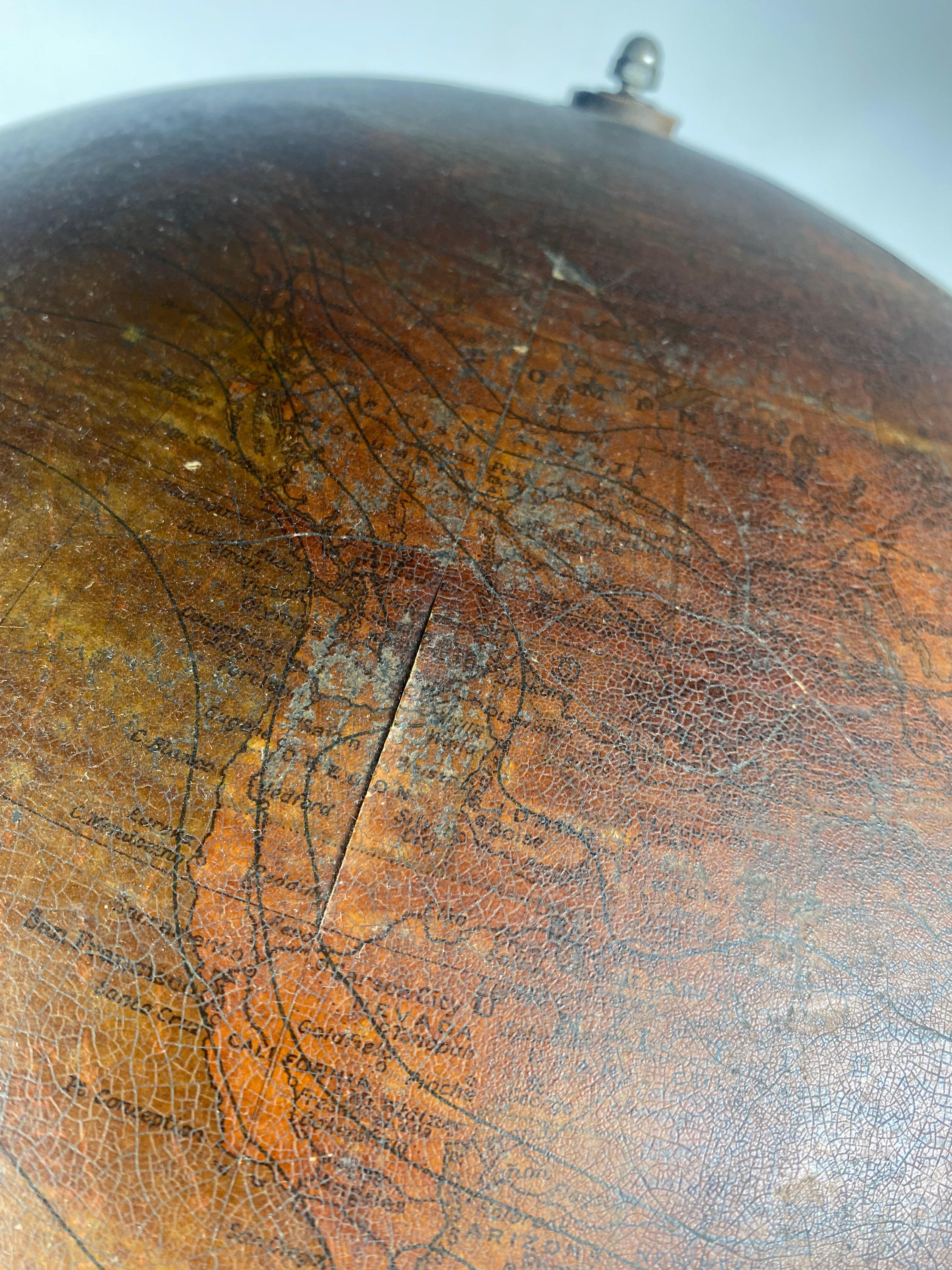 Early 20th Century Globe by Weber Costello Co. Ornate Cast Iron Base In Distressed Condition For Sale In Buffalo, NY