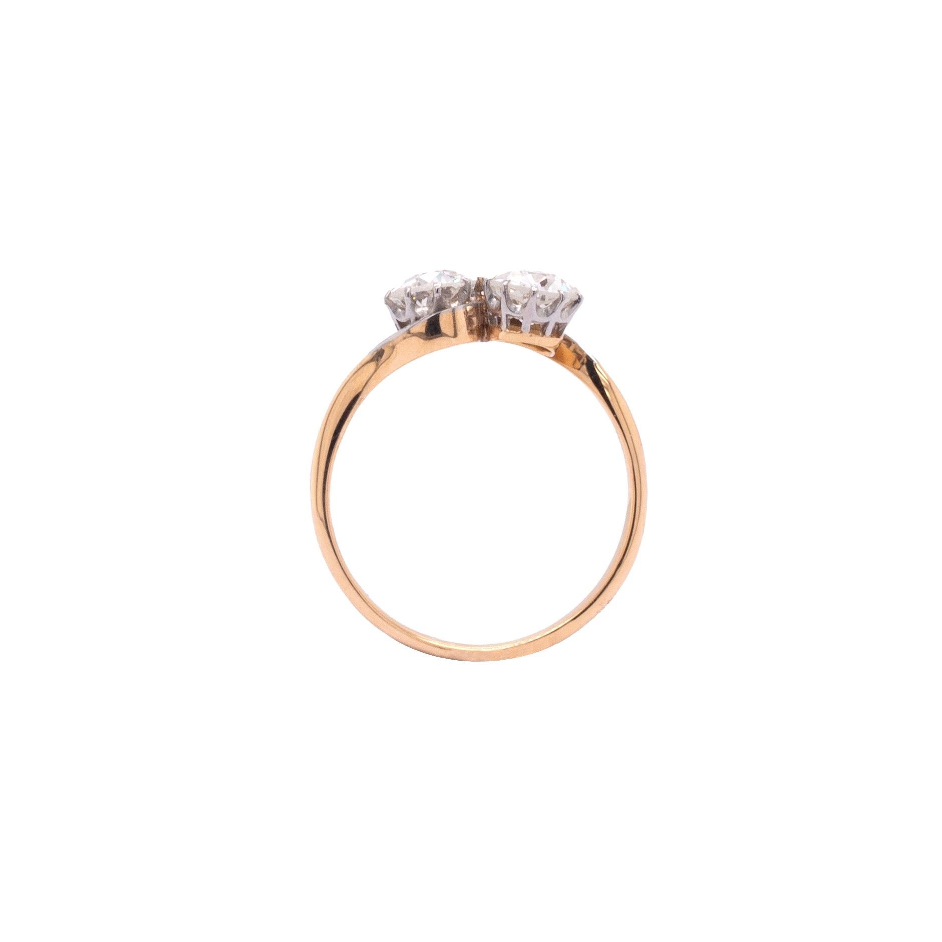 This sumptuous diamond toi et moi ring is perfection. 

Crafted in 18ct gold, a simplistic and elegant two-tone band measuring approximately 2mm at its widest point and tapering to approximately 1.3mm at the front, swirls in between two beautiful