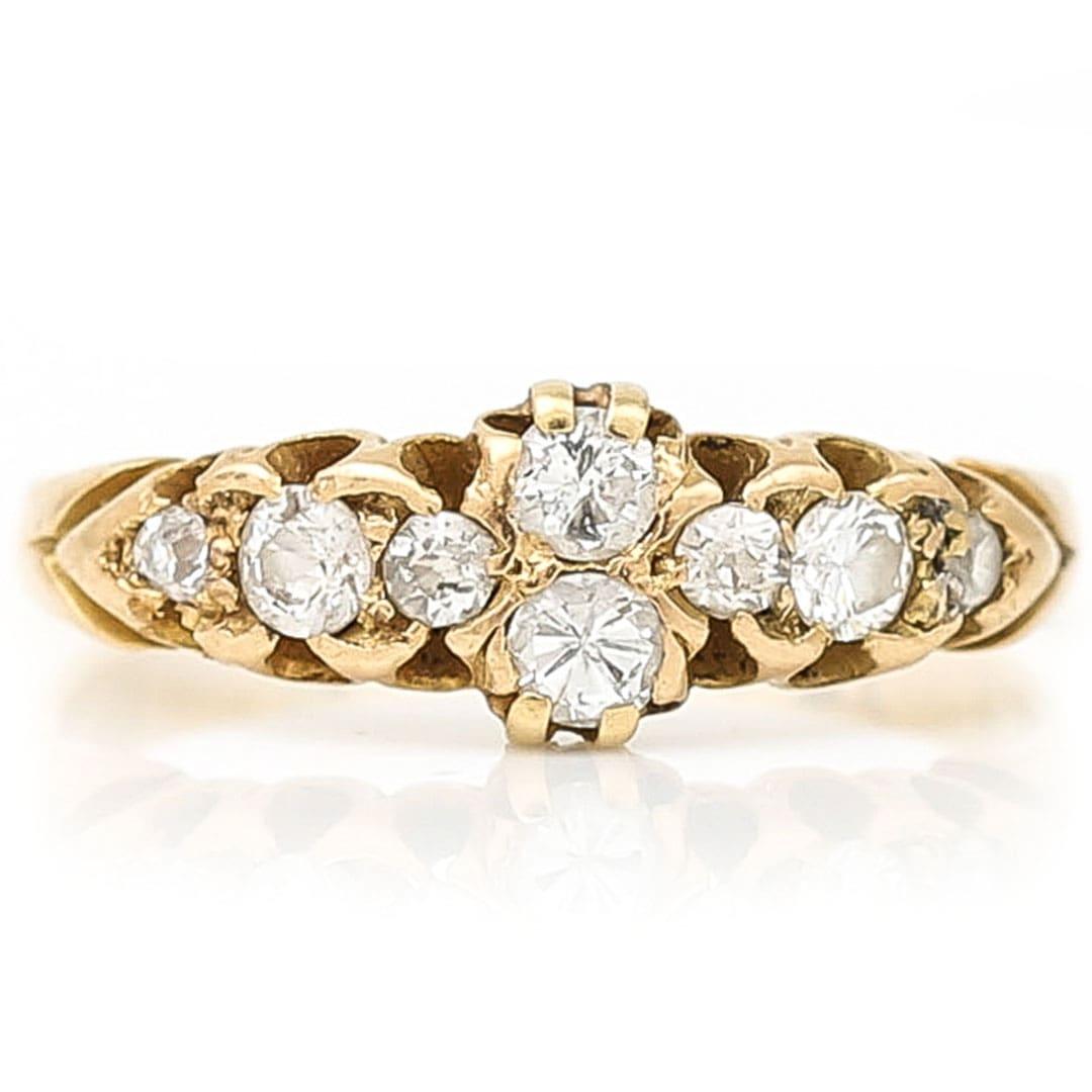 A beautiful early 20th century eight stone old European cut diamond ring dating from circa 1910. This super pretty antique diamond set band ring has 8 claw set early European city diamond across the head of the band at the centre of which are two