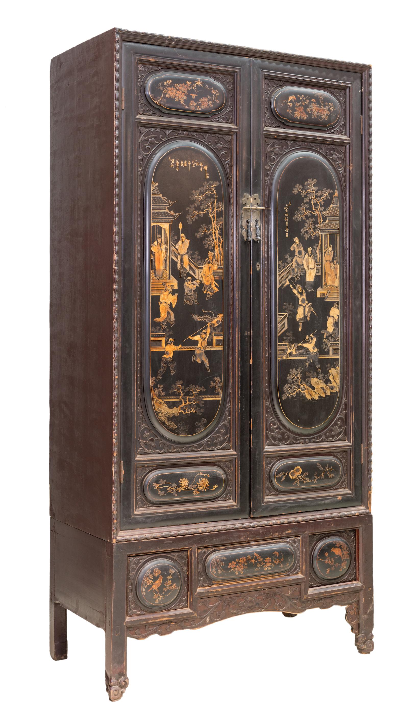 A tall and handsome 2-tier black lacquered cabinet with gold painting from Chaozhou city, Guangdong province, China. The two oval-shaped raised panels on the doors have very fine painting and depicts a lively opera troupe acting in the courtyard.