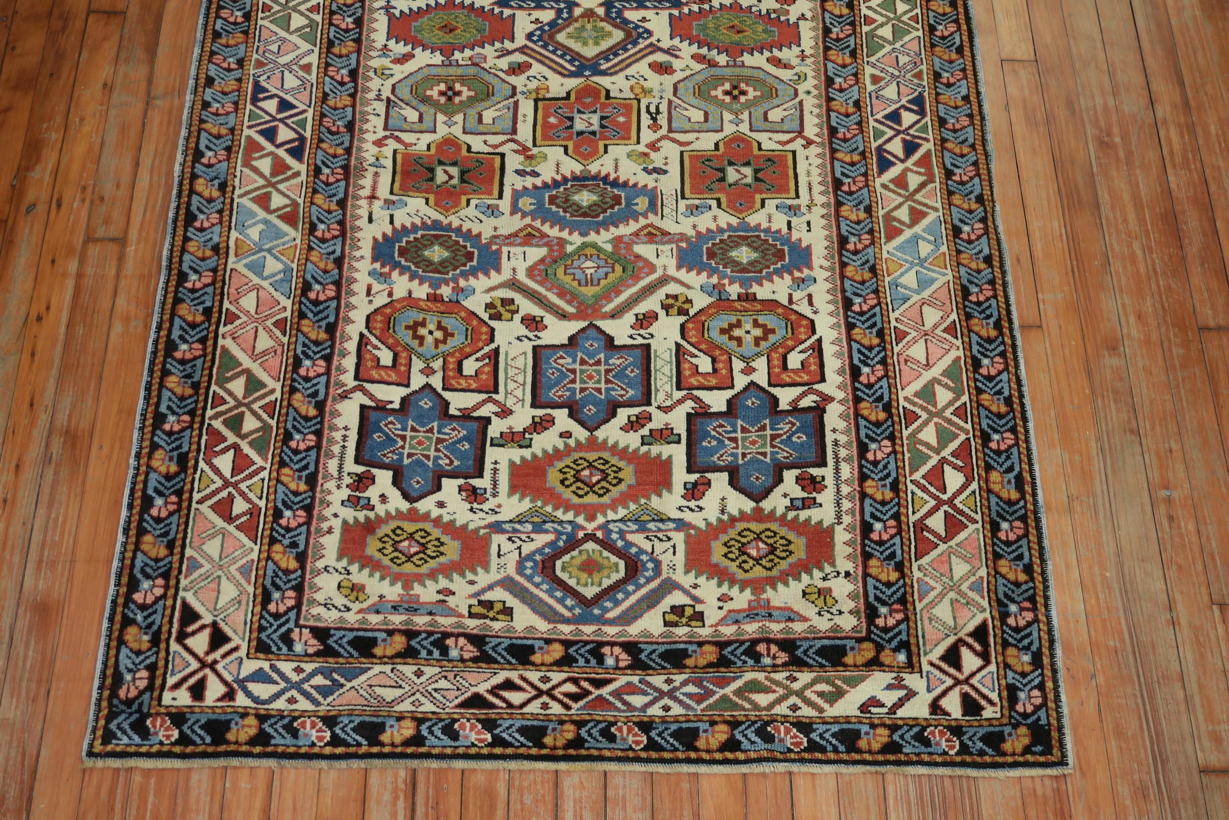 An early 20th century ivory field Caucasian Kuba rug.
This captivating Seichur Kuba presents motifs that trace a direct line to the most archetypal and inspired early Caucasian weavings. Offered on an aged rare ivory ground, the rug's border