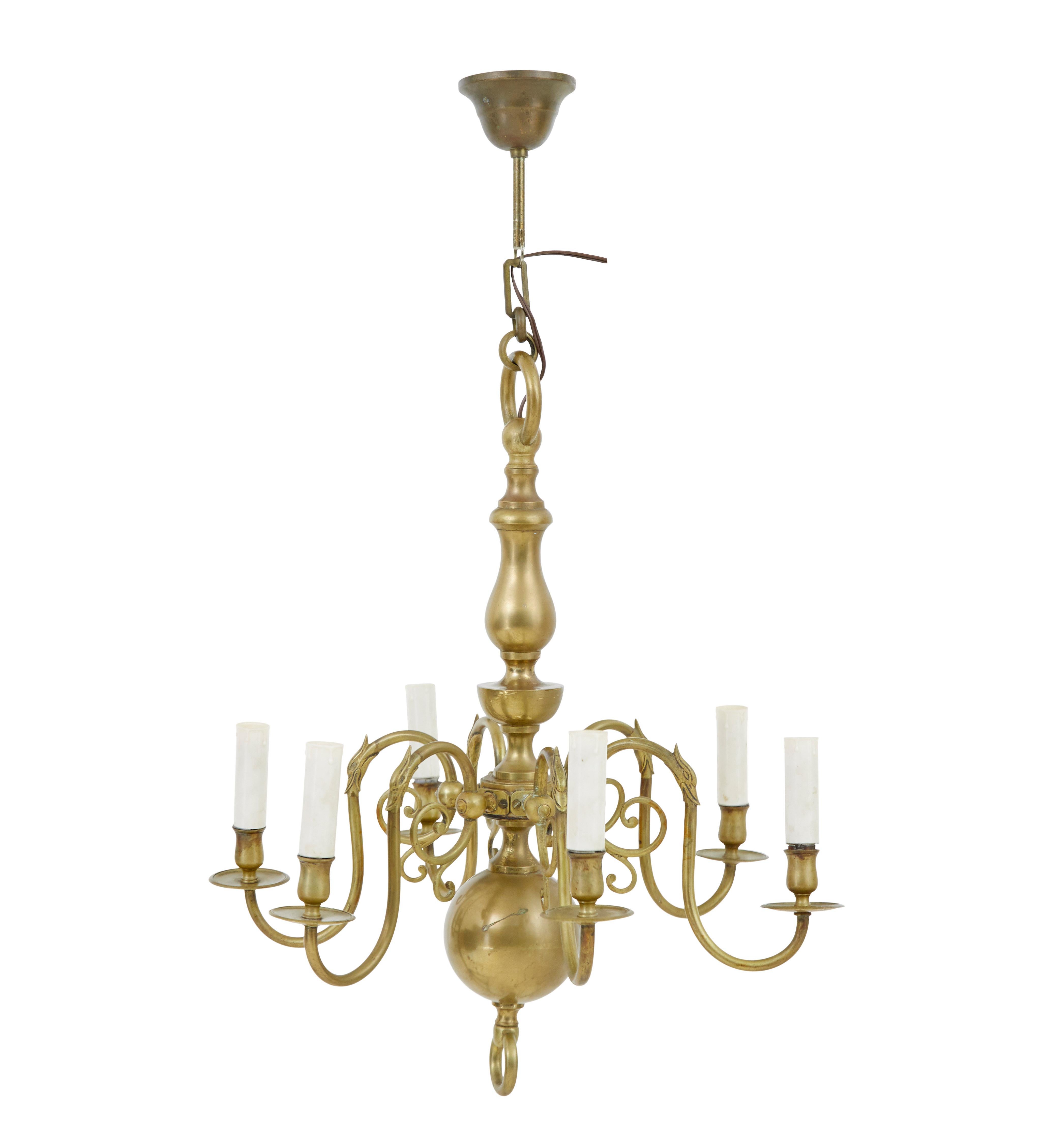 Early 20th century 6 arm brass chandelier circa 1910.

Functional light fitting that would be ideal for many rooms around the home.

Central stem with bulbous ball and hoop.  6 decorative arms which have been wired and covered with faux candle