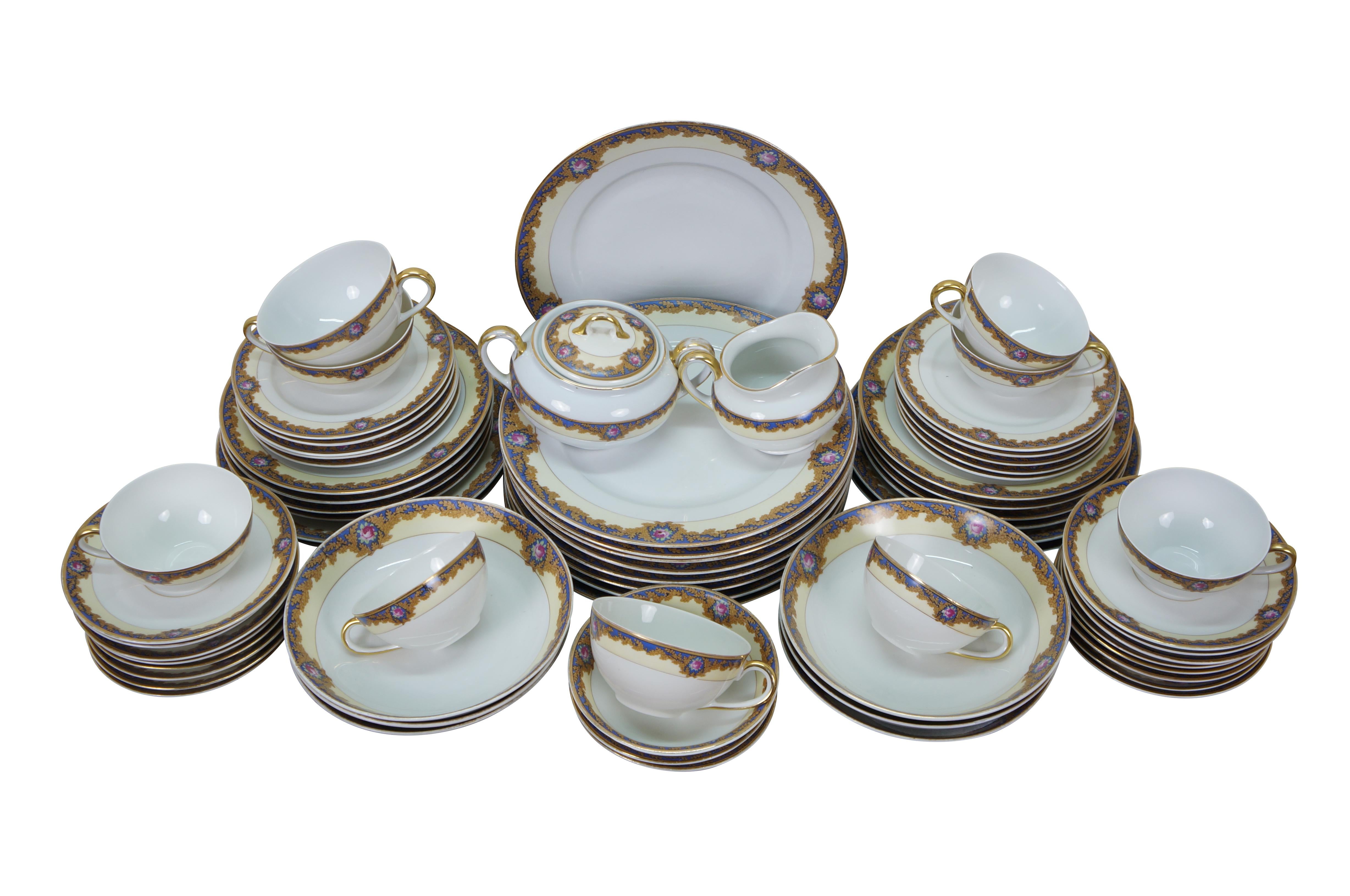 Early to mid 20th century 68 piece dinnerware set by Royal Bayreuth in the Beverly pattern. White porcelain with a cream and blue border accented with golden brown oak leaves and pink roses. Set includes: 9 Dinner Plates, 4 Salad Plates, 8 Dessert