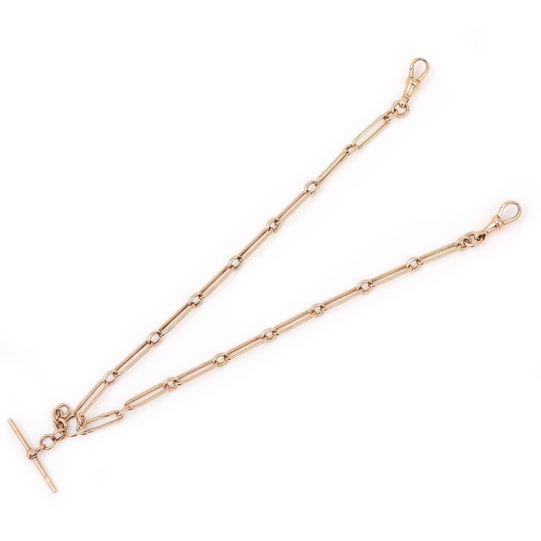 A solid, 9ct rose gold antique early 20th century Albert chain with alternating trombone and round uniform links with a sliding, removable T-bar. Every link is stamped ‘9CT' the two swivel clips and t-bar are also marked. The t-bar also has stamped