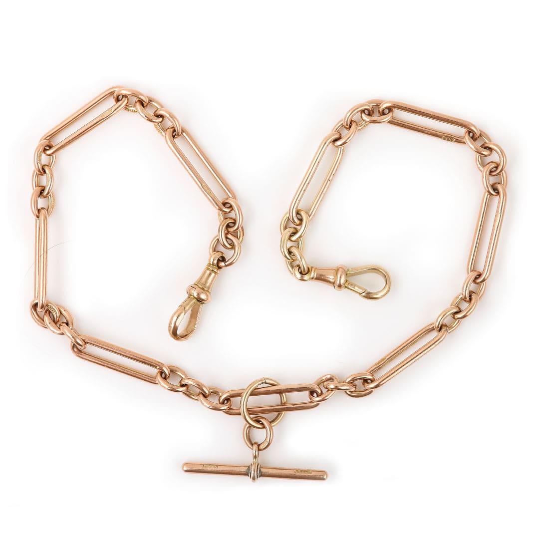 A splendid 9ct rose gold antique early 20th century Albert chain with alternating trombone and round uniform links with a T-bar. Every link is stamped ‘9' '375'  the two swivel clips and t-bar are also marked. The t-bar is affixed to a large jump