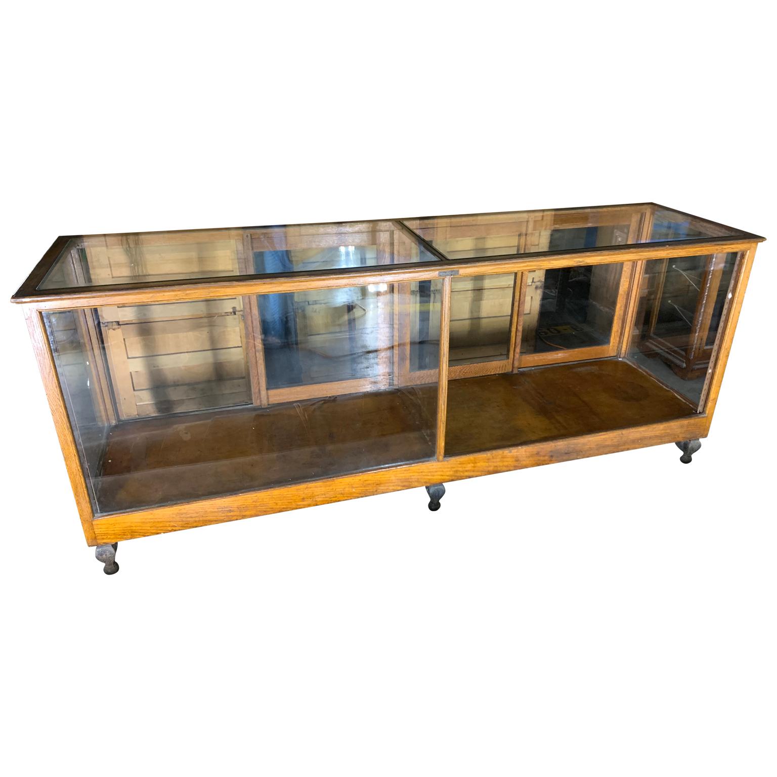Early 20th century A N Russel & Sons wooden glass top display case vitrine.