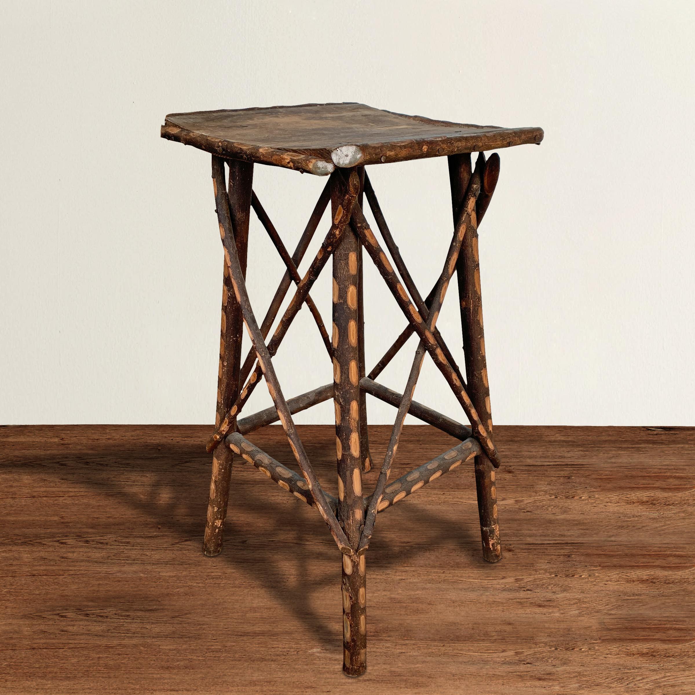 A charming and quaint early 20th century American Adirondack-style twig table with the most unusual spotted carved bark pattern we've seen on pieces of this style. The top is made from an early 20th century American orange crate retaining traces of