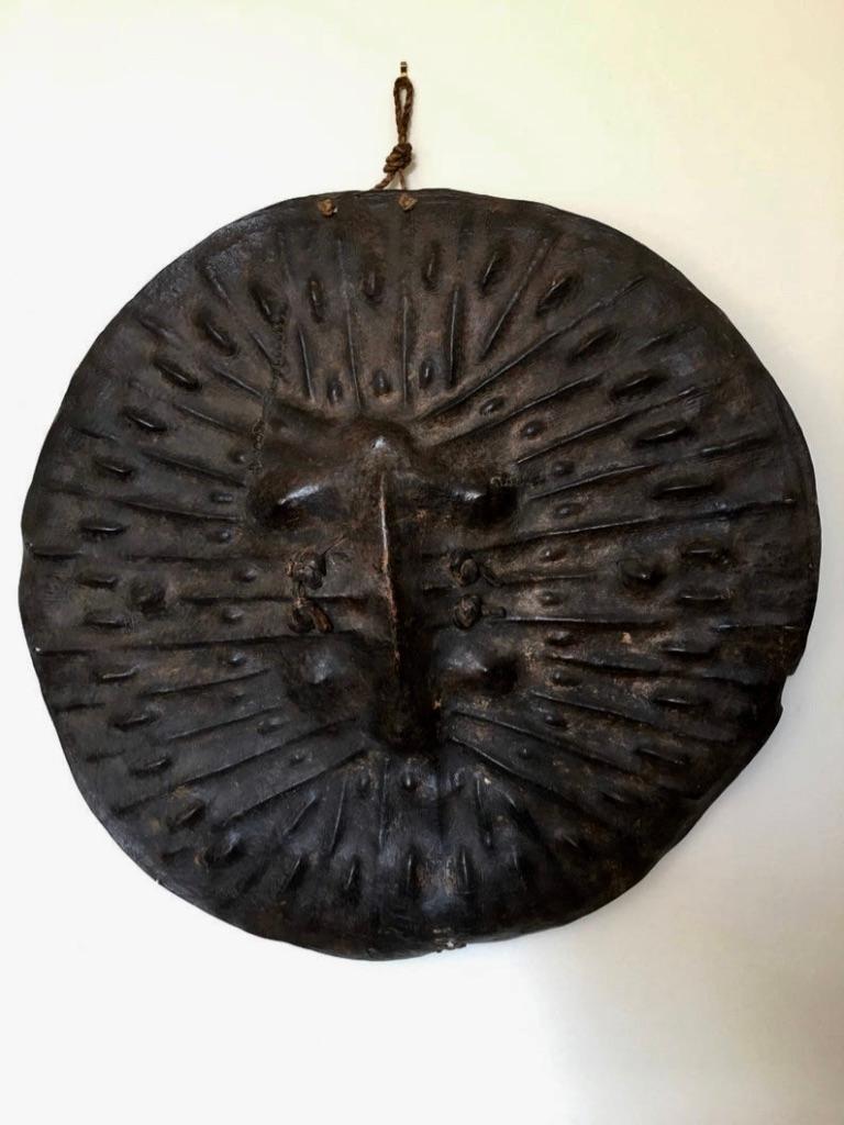 This striking African Ethiopian Shield is from the Oromo tribe. Extremely thick hide, probably Hippopotamus, is decorated with dimpled impressions and extreme patination. The shield has the look of some impossible creature’s shell, a wonderful