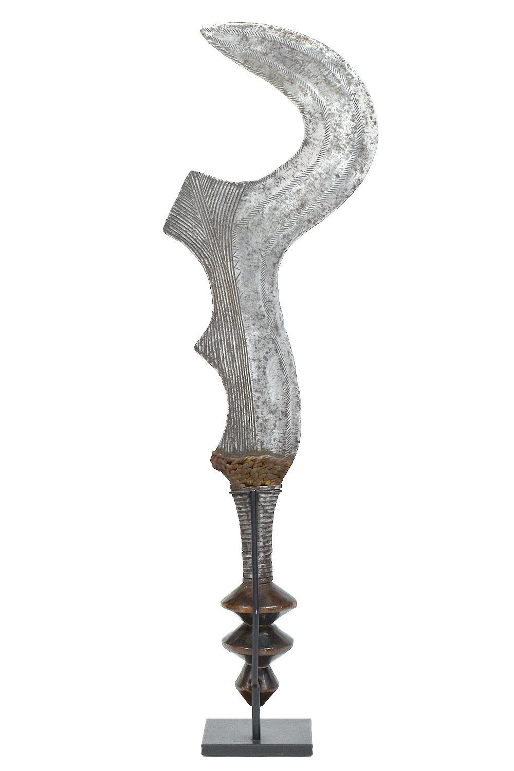 Early 20th century African Ngulu Ceremonial status sword, D.R. Congo
Ngombe Culture, D.R. Congo
Iron, Wood, Leather

This status symbol is carried by a man as an emblem of rank. The sword is a single edged, iron blade engraved with an elaborate