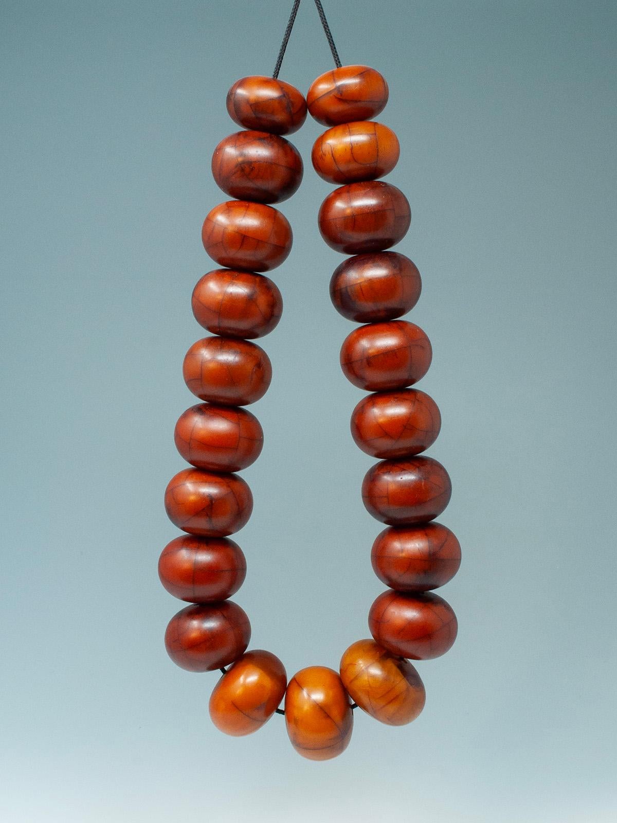 Early 20th century African Bakelite beads

A beautiful strand of 21 African “amber” beads measuring 26 inches. The beads range from 1-1.5 inches high and all have small holes.

