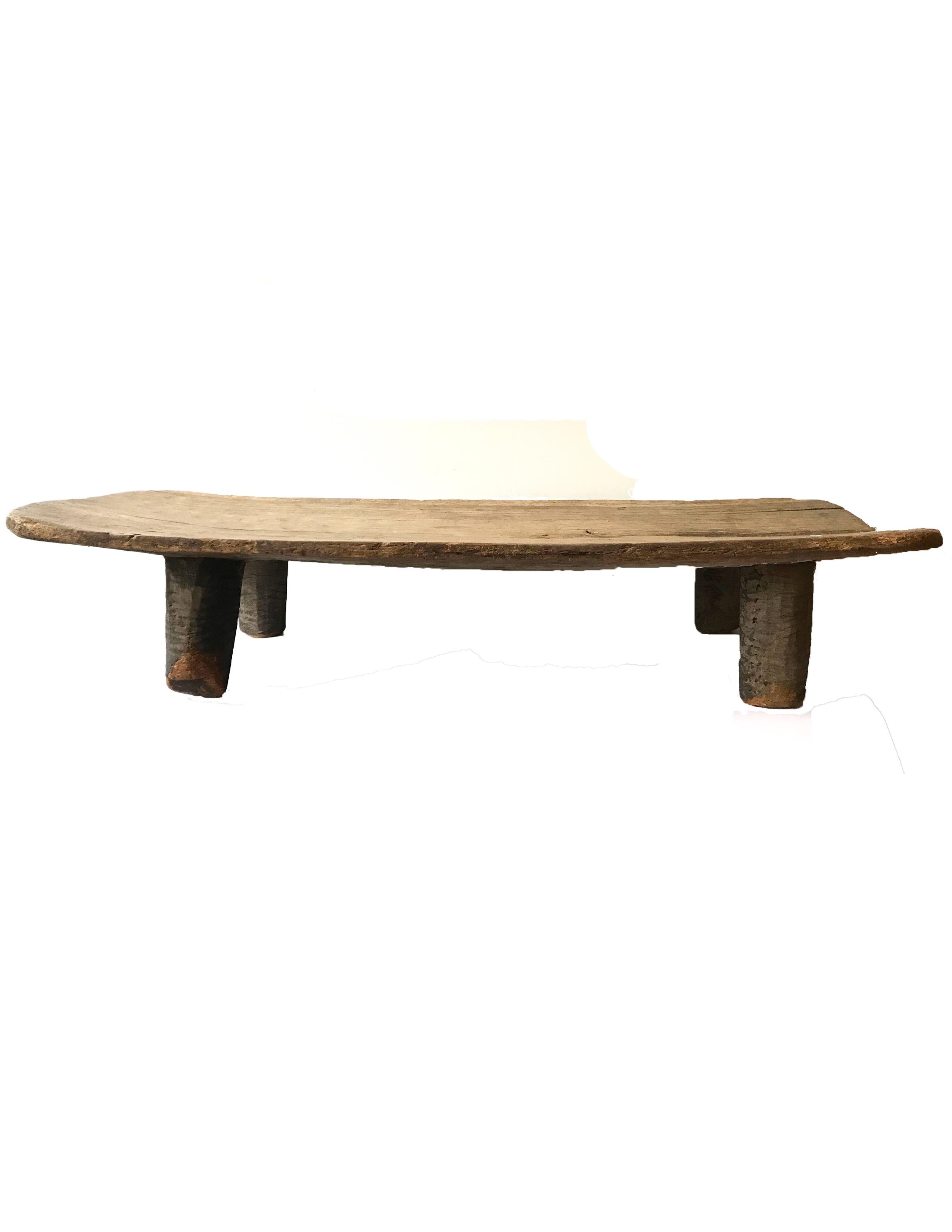 Early 20th century African weathered wooden bench/table.


Measurements: 62 in. W x 24.75 in. D and between 11-13 in. H.

 