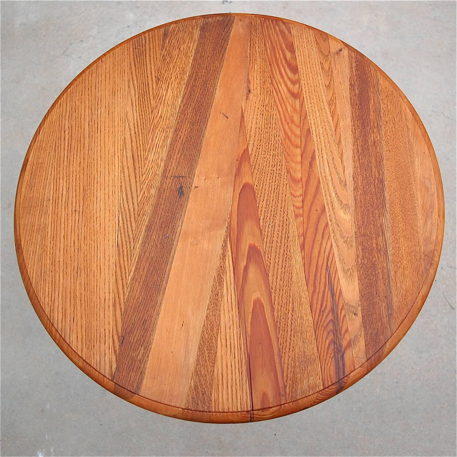 Round, circular aviation accent or side table made from half a wooden aircraft propellor featuring seven, curved laminations of different types of wood with a beautiful grain and finish. It still bears some of its original engravings (see photo) and