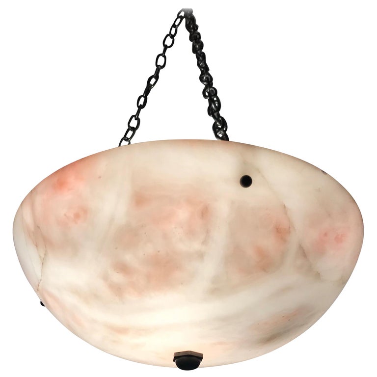 Classical shape and rare color alabaster light fixture. 

This large handcrafted, mid-size alabaster pendant is beautiful in shape and unusually white and pink in color. However, what makes this Art Deco era light fixture really stand out, is the