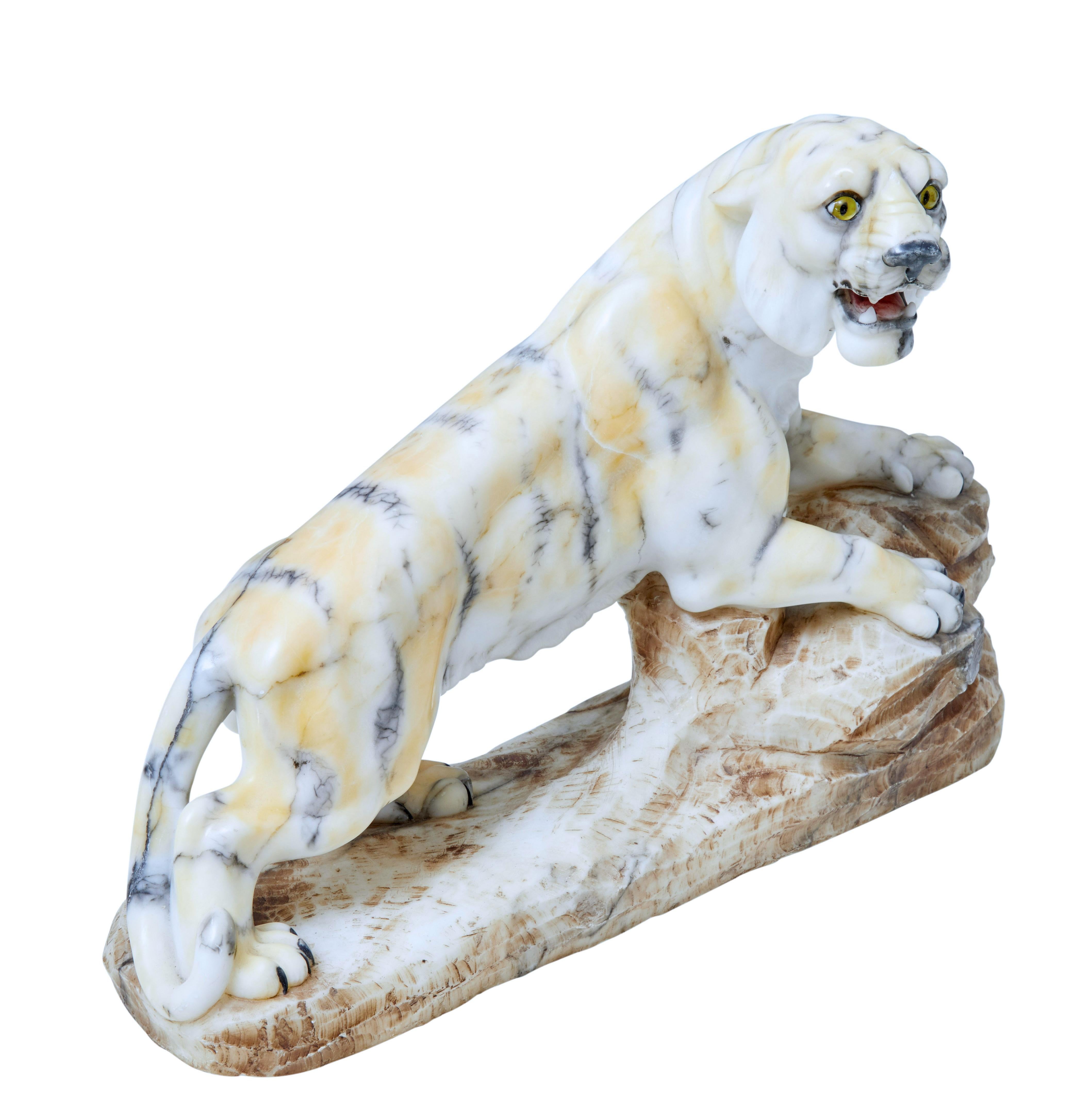 Good quality Art Deco period tiger, circa 1920.

Shown in a semi prone position while standing on a tree trunk or large branch.

Good size with no losses, minor surface marks.