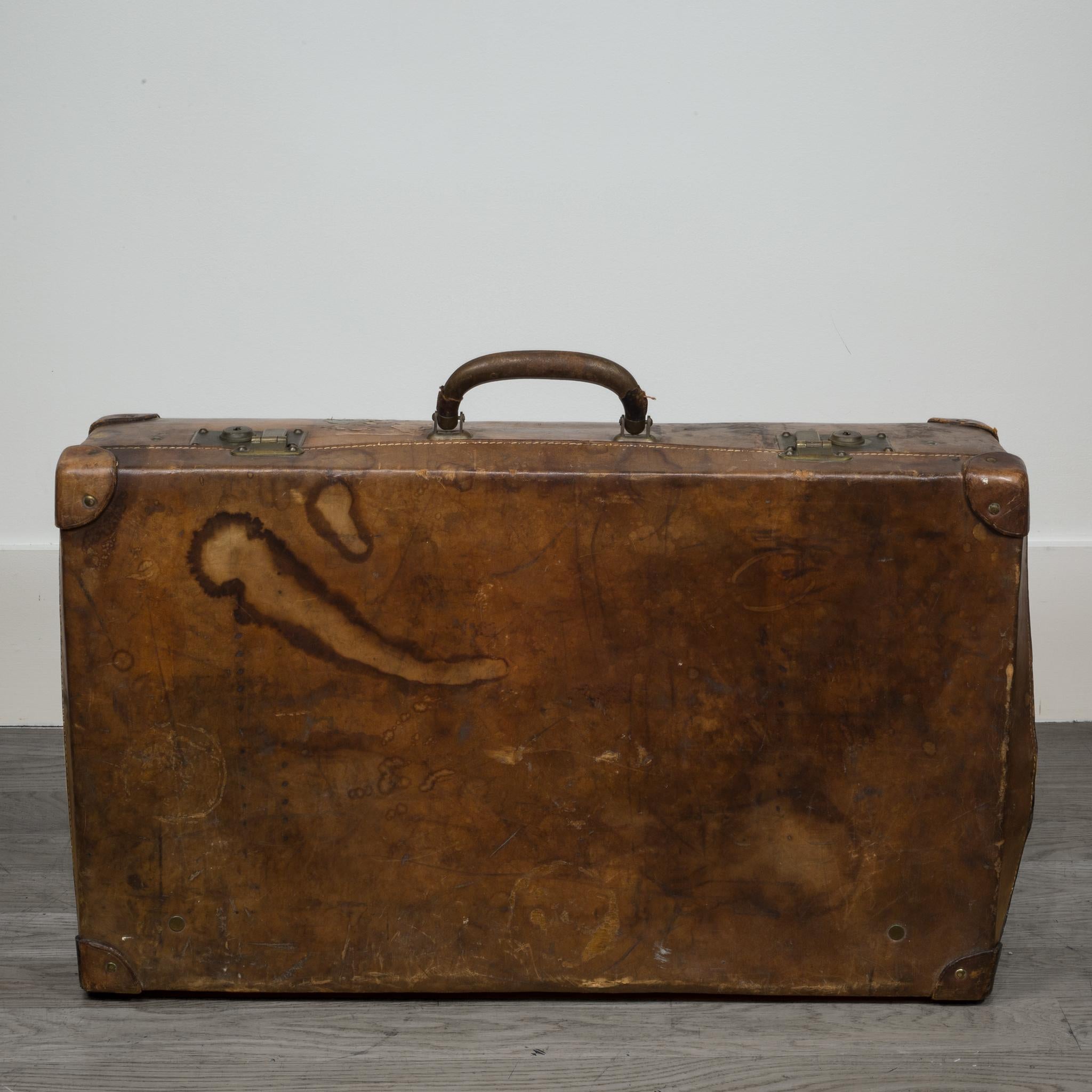 ABOUT
This is an original leather, travel suitcase. The suitcase is all leather with double leather corners, leather handles, brass locks, and detailed whip stitched finishes. The piece has retained its original finish and is in good condition with