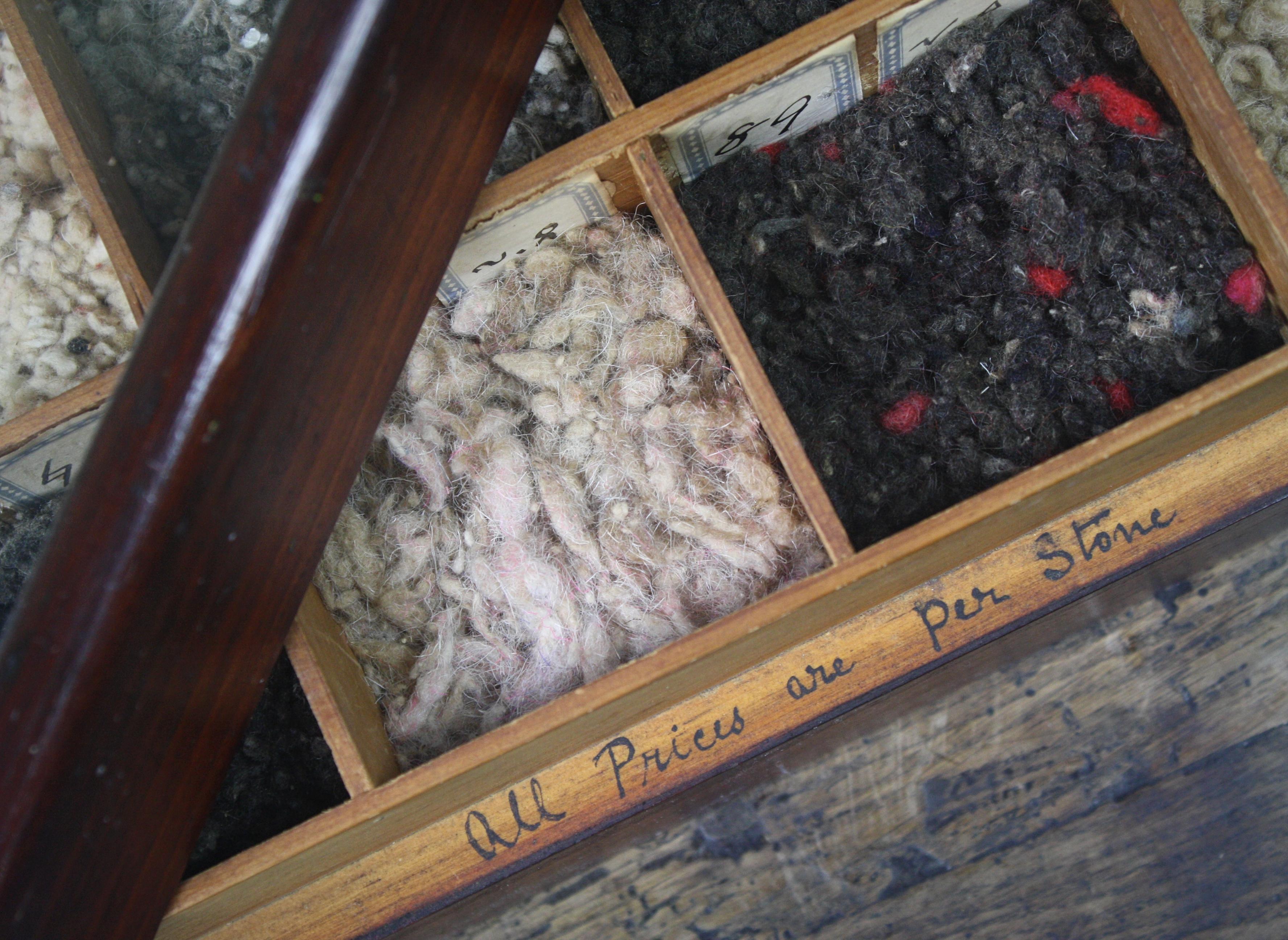 A early 20th century pine segmented box containing various wool samples, with original labels. 

The box has a removable glazed top, secured with two brass latches. A hand written label on the interior rim reading

