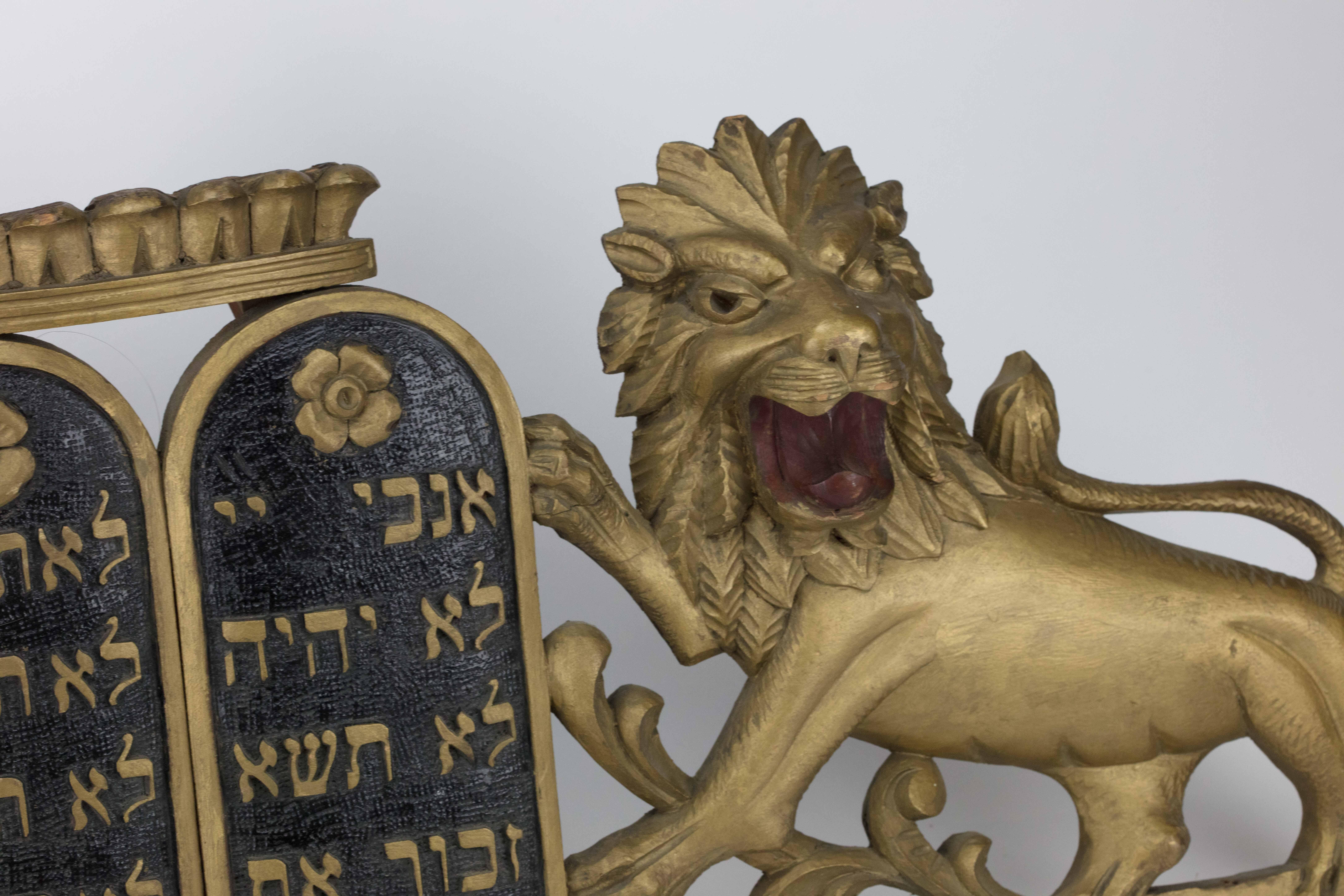 Hand carved wooden ark pediment, gilded lions flanking the Decalogue, USA, circa 1900.
These wood carvings are early examples of Jewish American Folk Art in the early 20th century. They show how a form of art initially designed for carousel