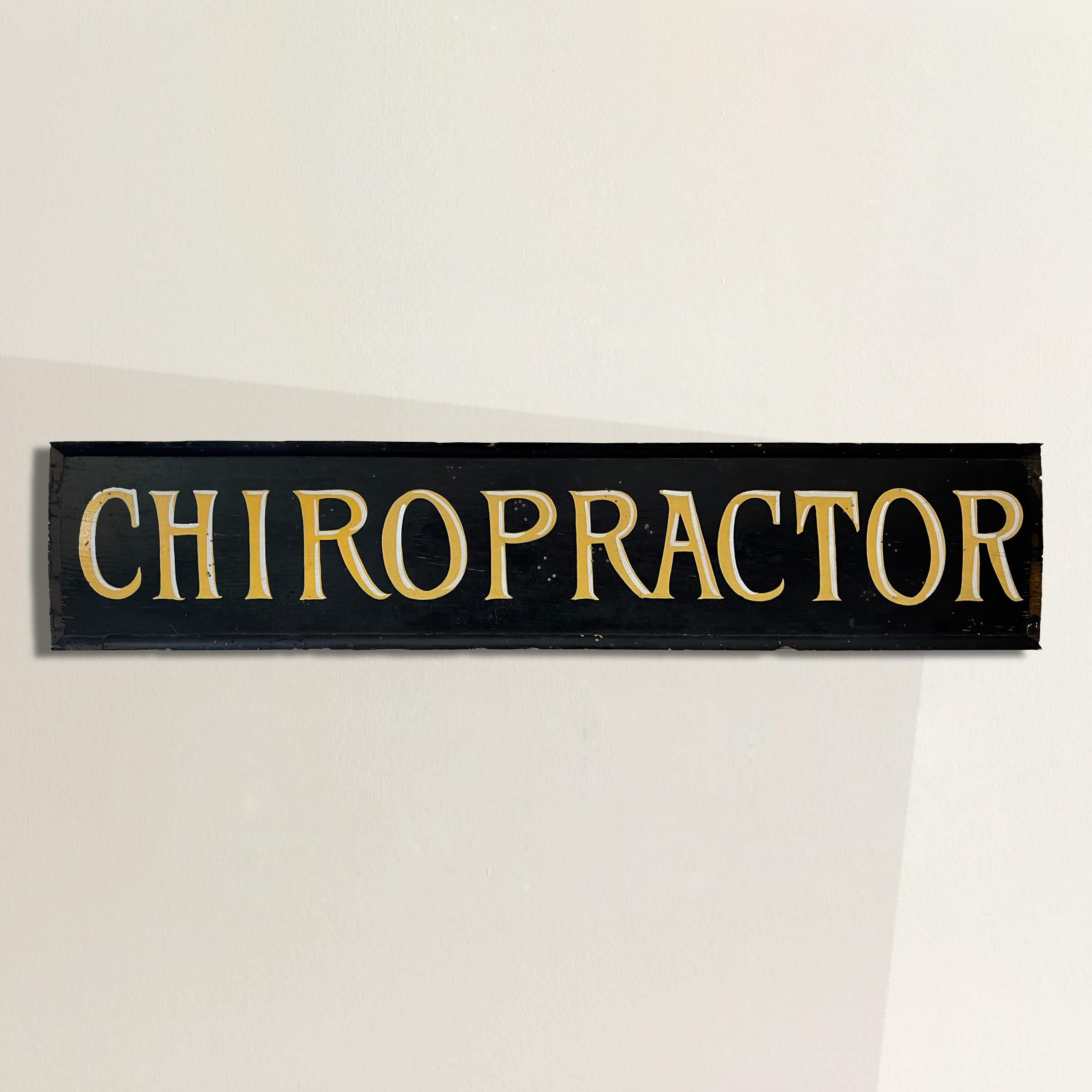 Own a piece of Wisconsin's history with this early 20th century hand-painted sign from an early 20th-century chiropractor's office. The sign, found in a barn in the heart of Wisconsin, features a classic black background adorned with bold, radiant