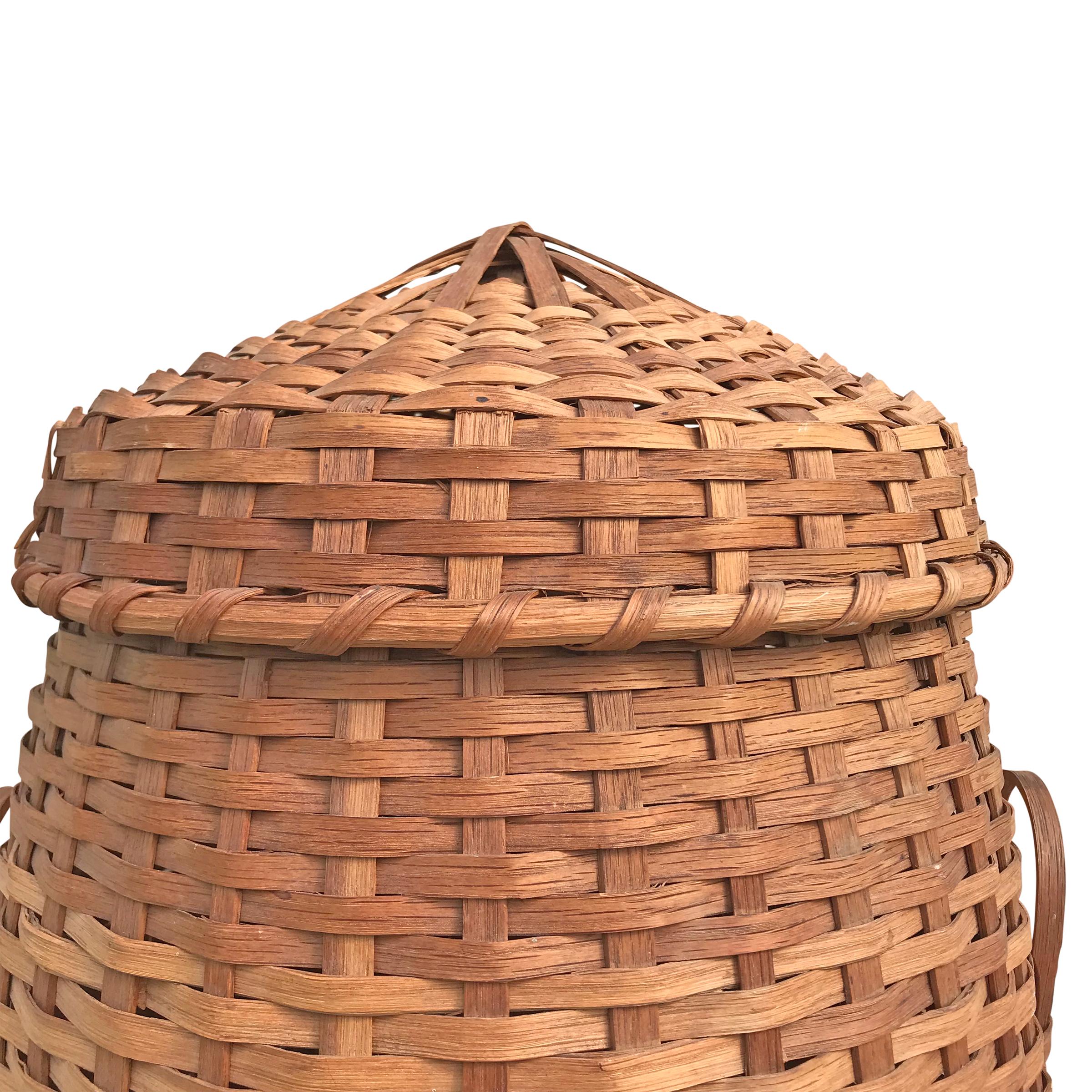 An incredible early 20th century American handwoven oak split feather basket with bent oak handles and a tightly fitted lid. Every farmer knows that nothing is wasted, not even feathers! Feather baskets were used on American farms to store feathers