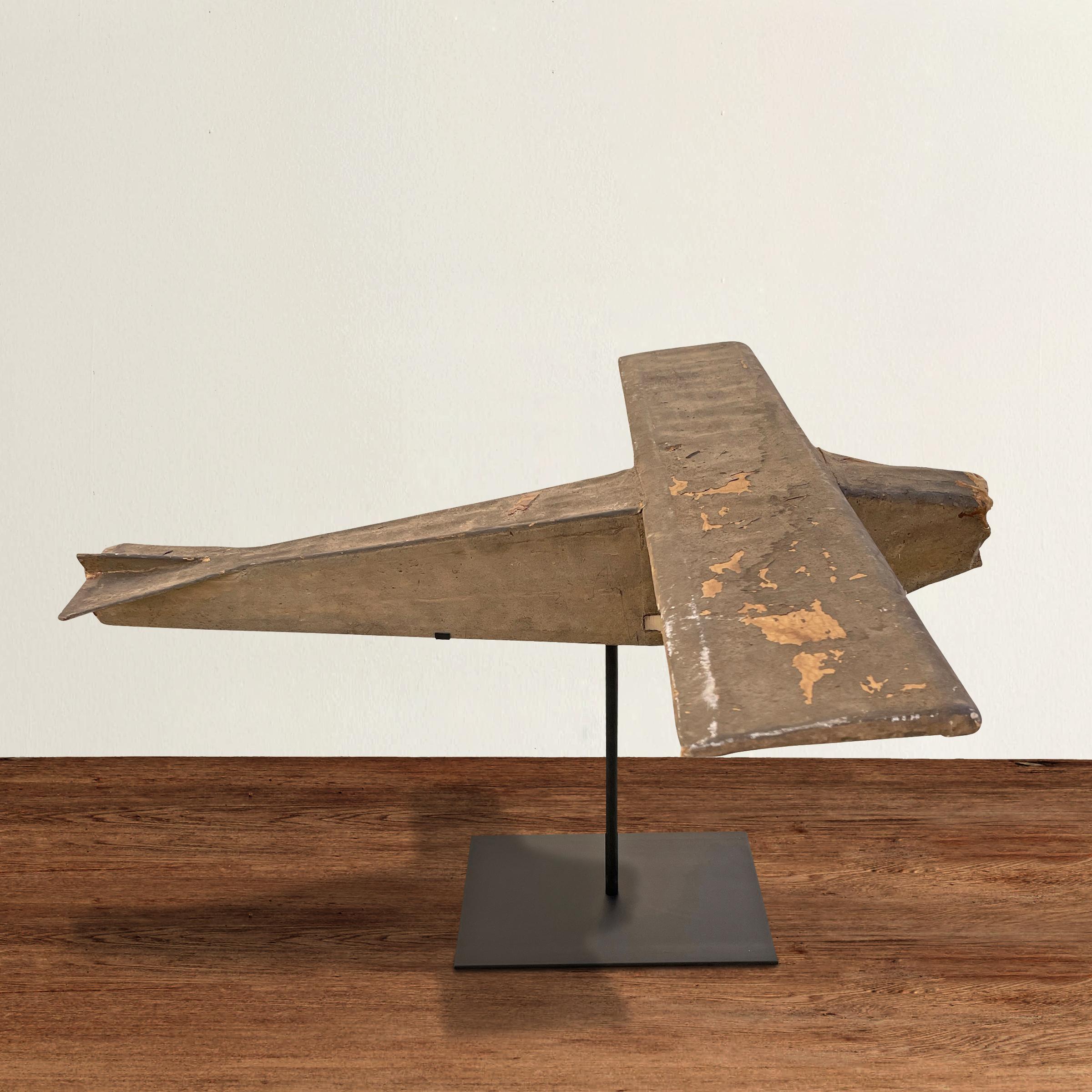 A wonderful and charming early 20th century American bush plane model constructed with painted canvas stretched over a wooden skeleton, and mounted on a custom steel mount.